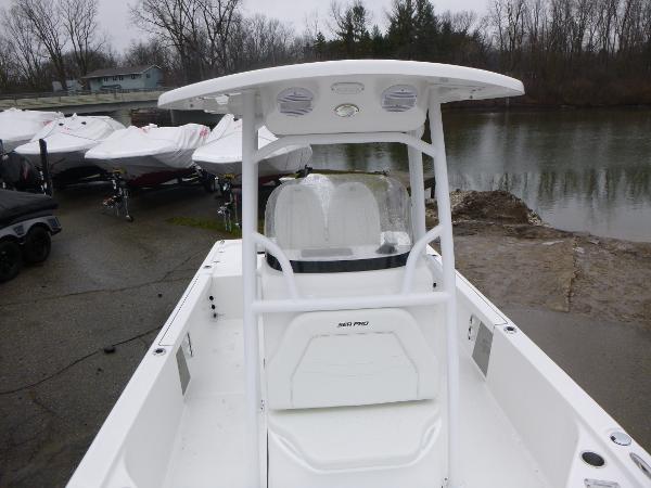 2025 Sea Pro 250 Bay boat at a dockside, featuring a sleek white design.