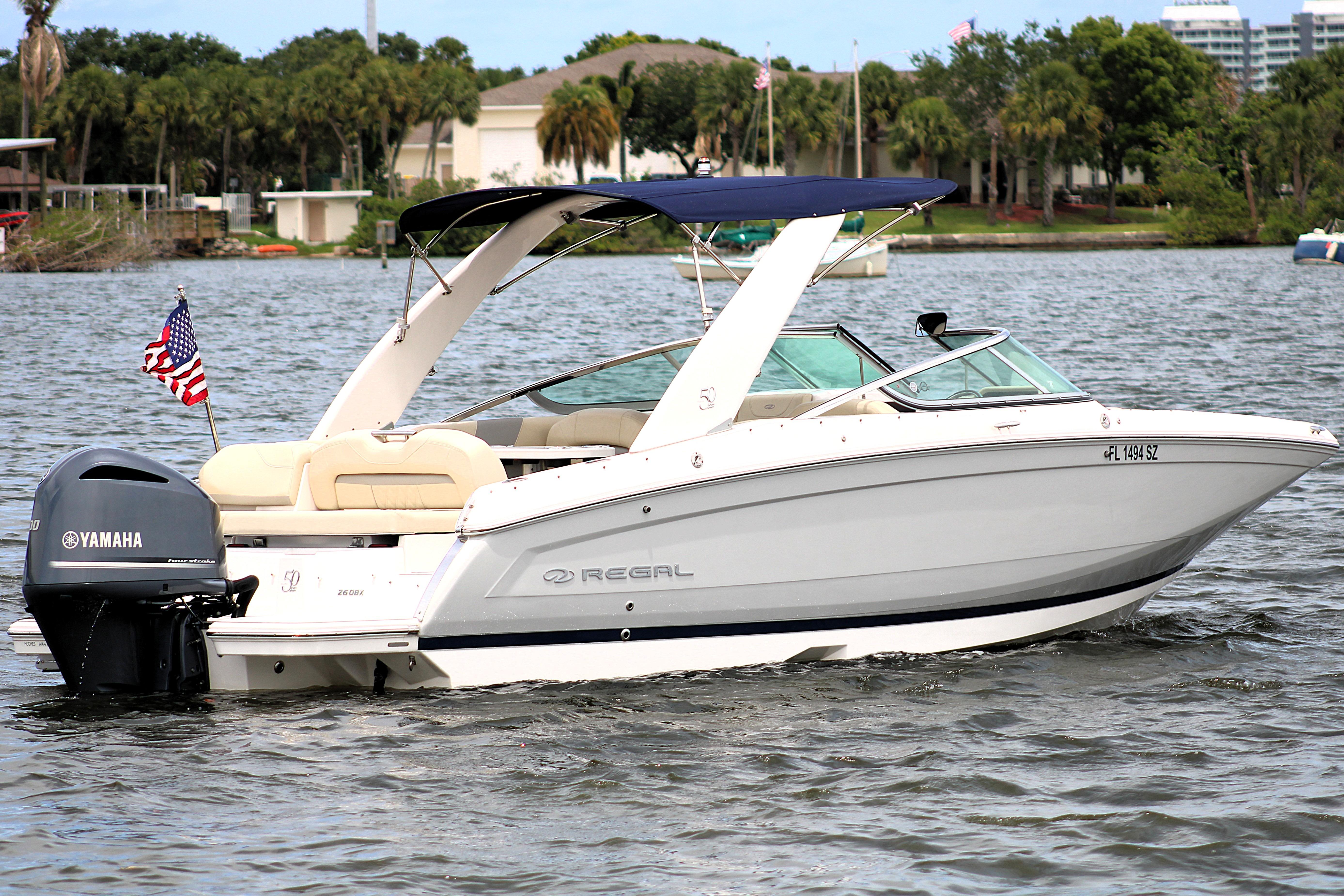 2021 Regal 26 OBX boat with Yamaha engine on a scenic lake.