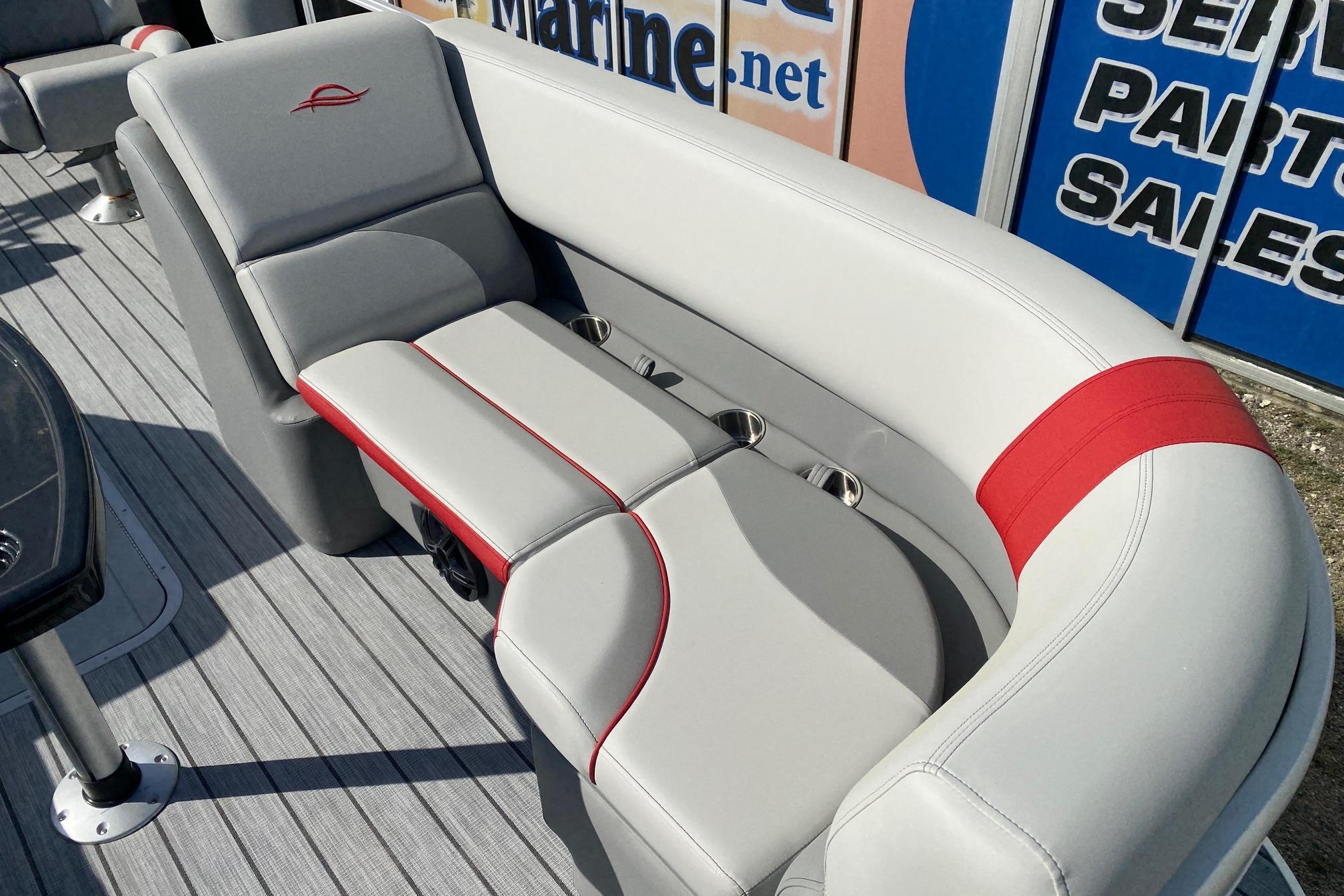 Luxurious seating on 2026 SunCatcher Select 322RC pontoon boat with stylish red accents.