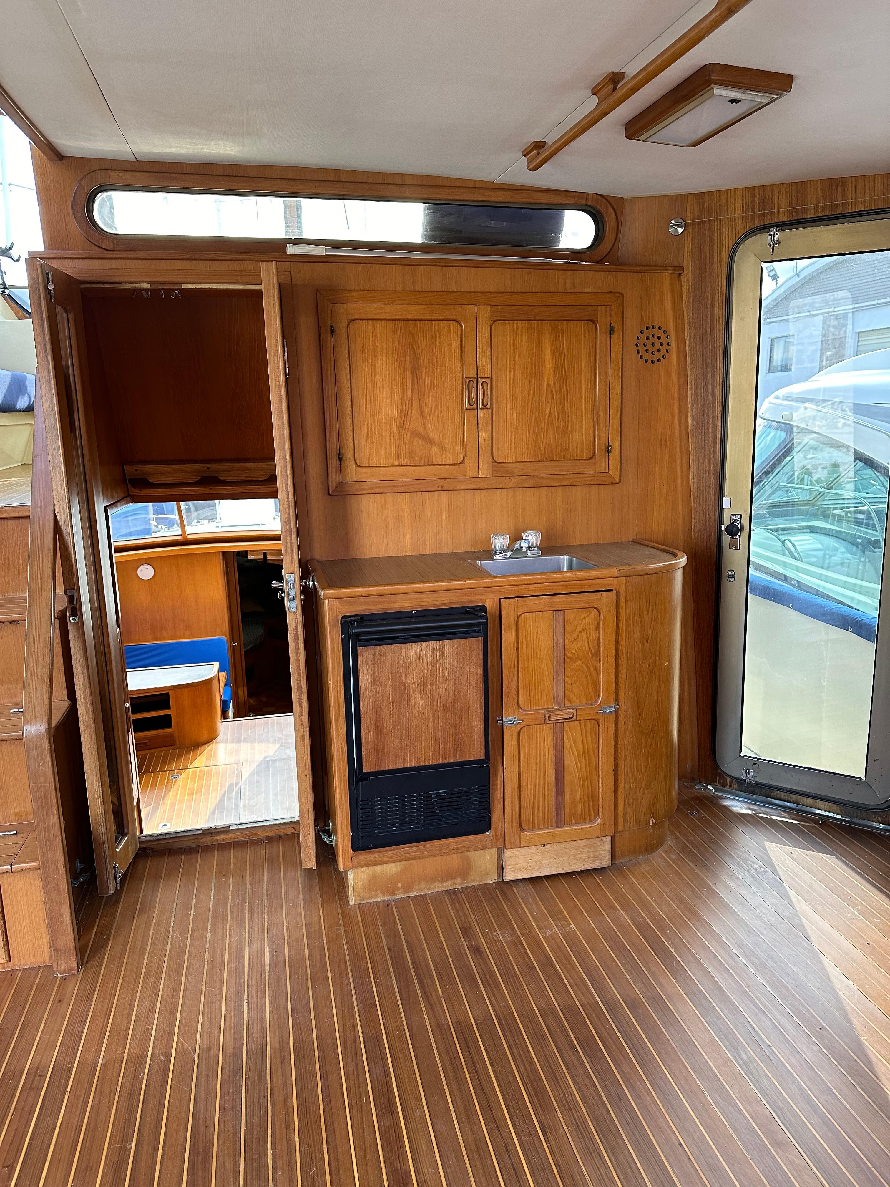 Interior of 1988 Vista 43 Motor Yacht with wooden cabinetry and flooring.