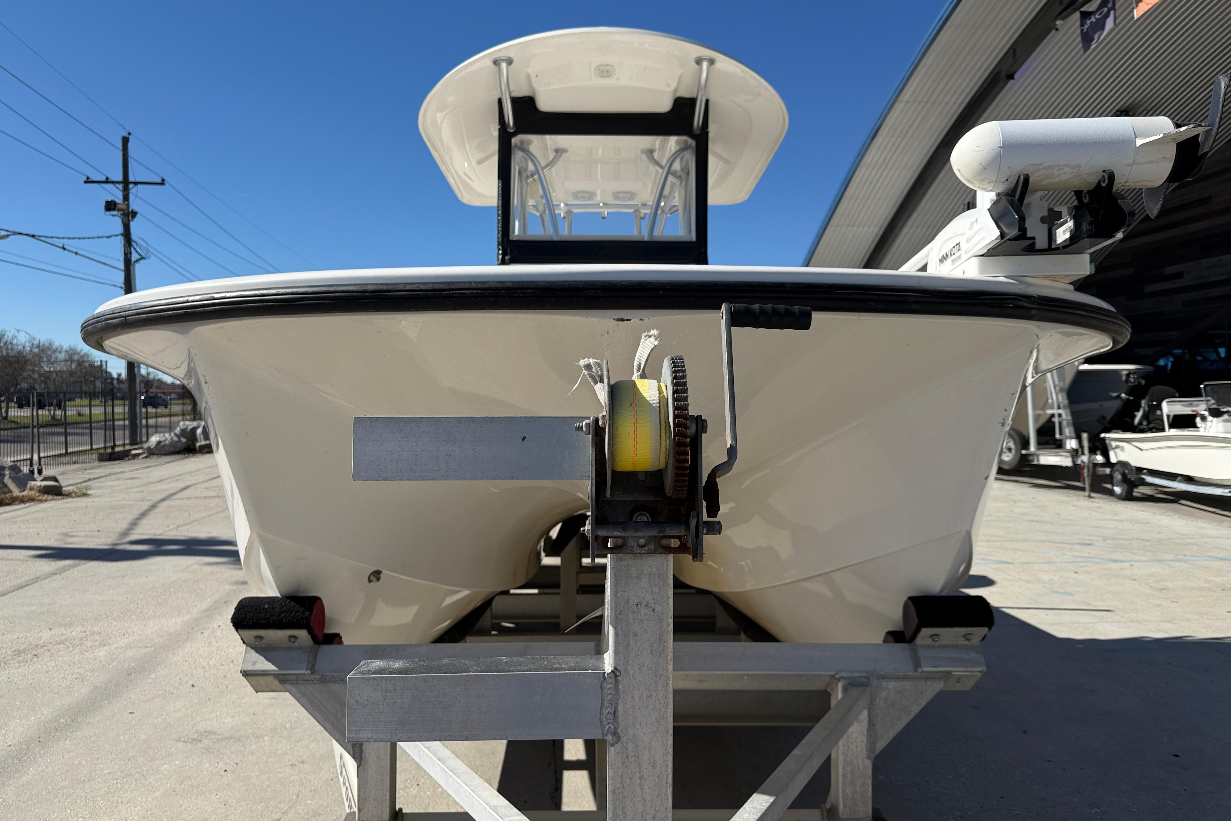 2020 Tideline 235 Hybrid boat on trailer, front view, under clear blue sky.