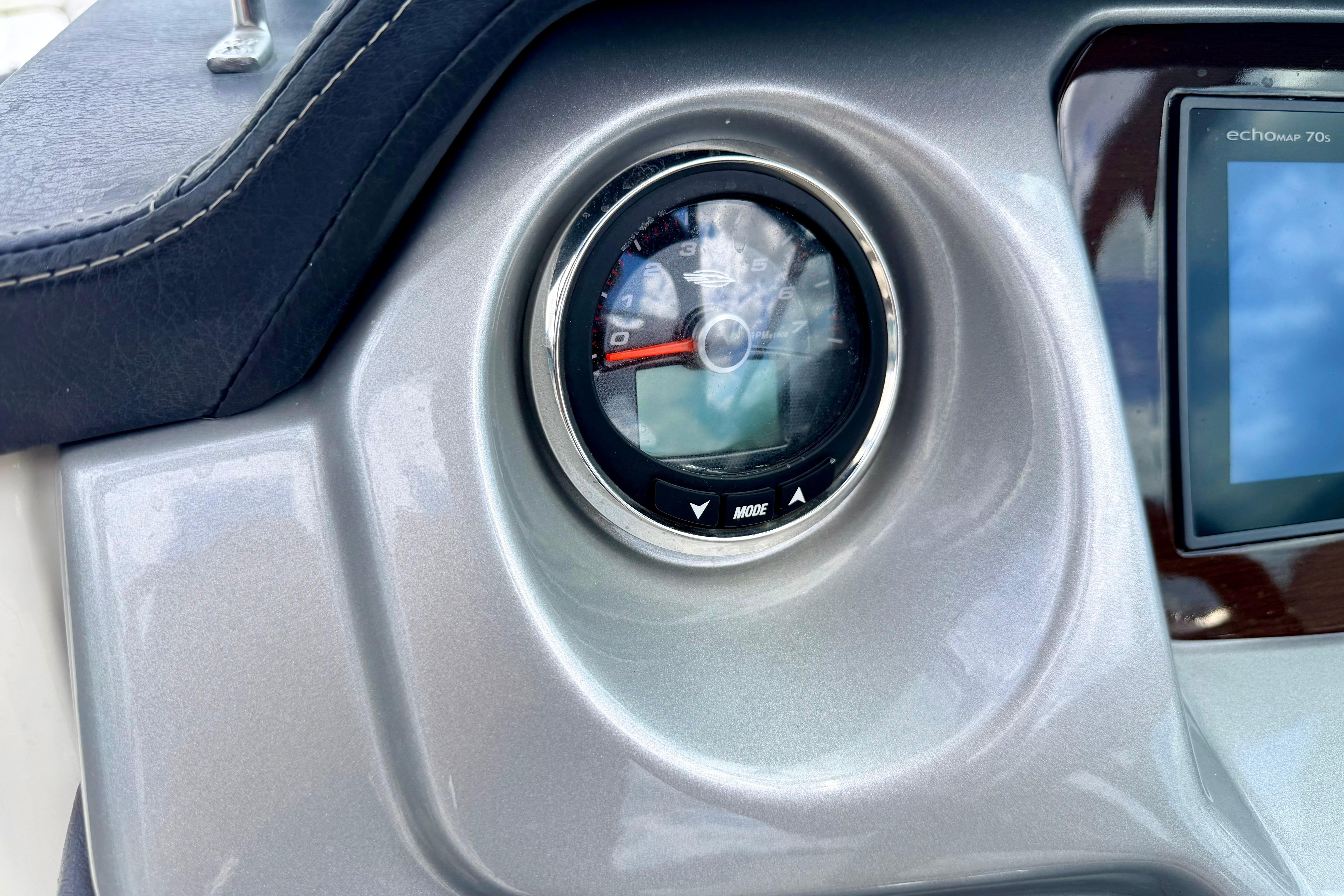 Dashboard of 2015 Chaparral Sunesta 264 boat with gauge and display screen.