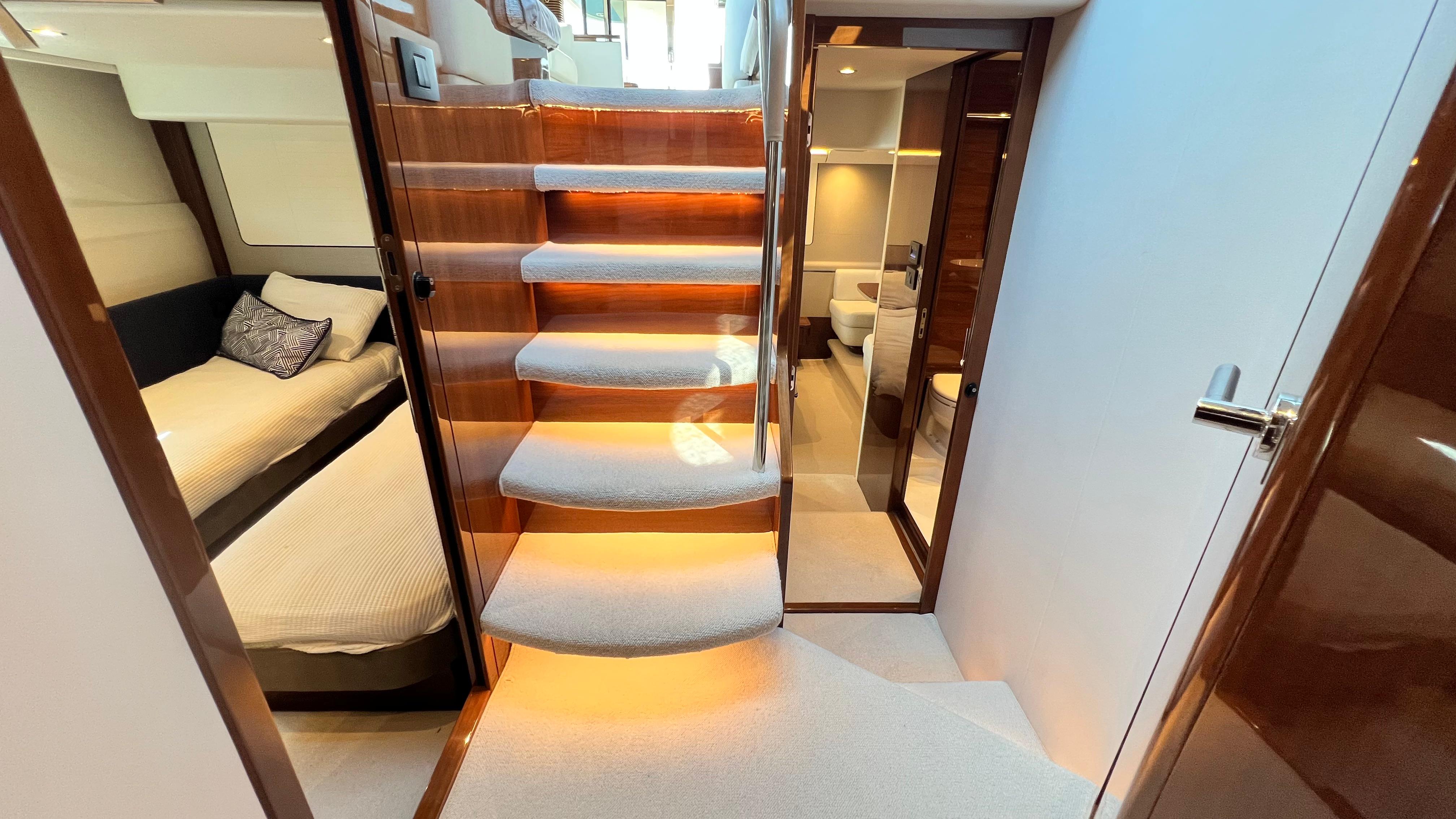 Luxurious interior of 2019 Princess F62 yacht with elegant staircase and cozy cabin.