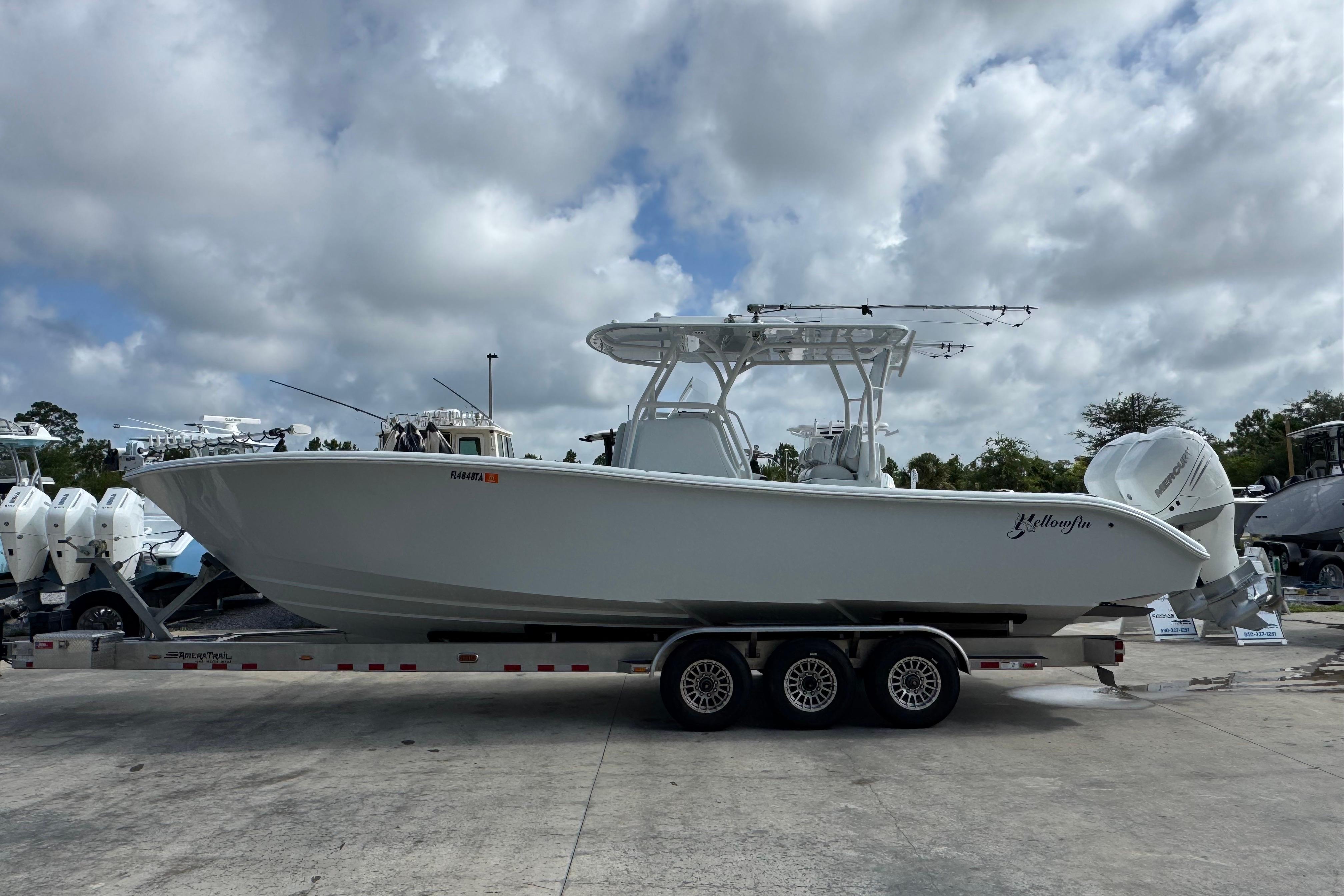 2022 Yellowfin 32 Offshore boat on trailer under cloudy sky.