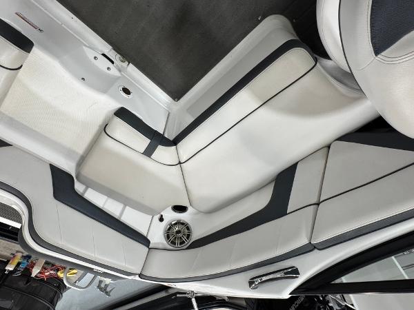Interior seating of a 2014 Yamaha Boats 212X, featuring sleek white and black upholstery.