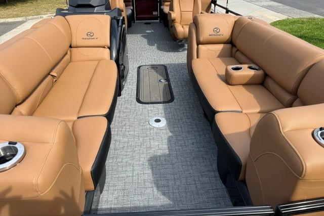 Luxurious 2026 Regency 230 DL boat interior with tan leather seating and cup holders.