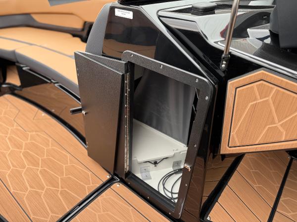 2025 Yamaha Boats 255XD interior storage compartment with sleek design and wood accents.
