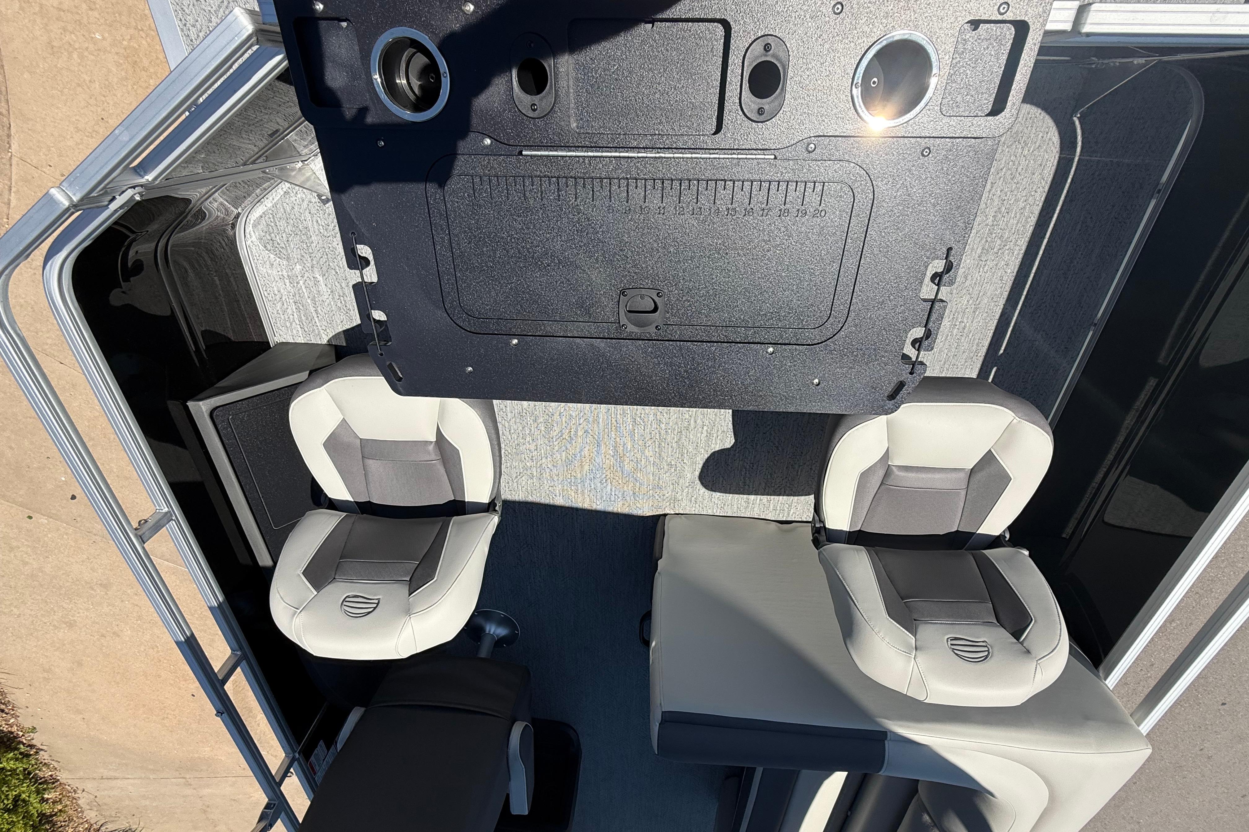 Interior view of 2026 Sun Tracker Fishin' Barge 22 DLX with seating and control panel.