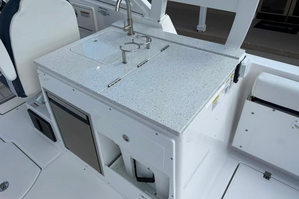 2026 Sea Fox 288 Traveler boat kitchenette with sink and storage.