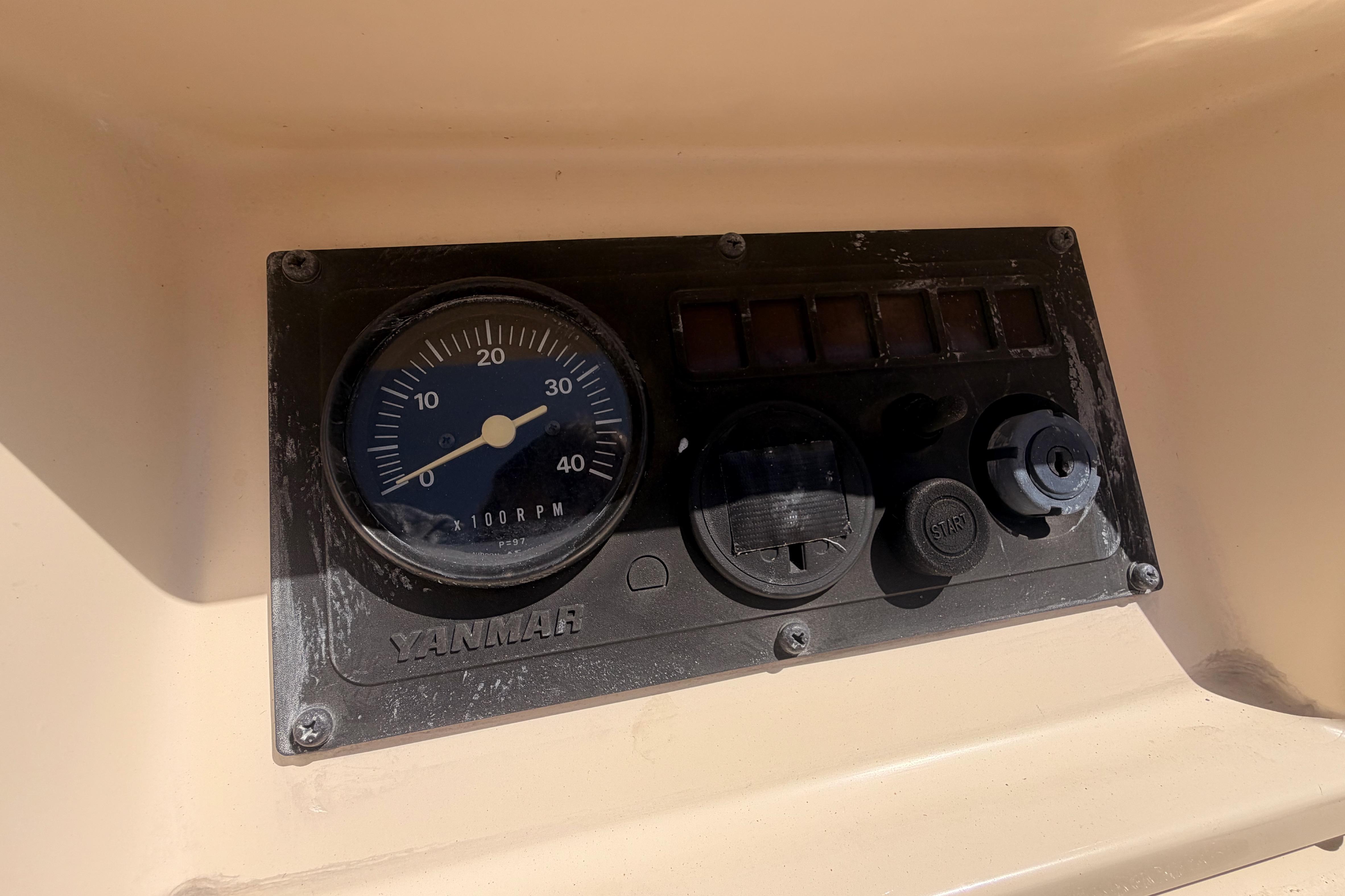 Control panel of a 1991 Caliber 33 sailboat with Yanmar tachometer.