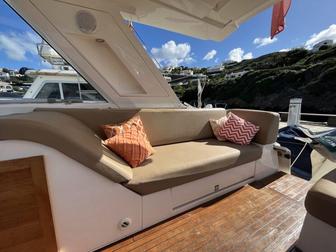 Luxurious seating area on a 2012 Sealine SC 47 yacht with decorative cushions.