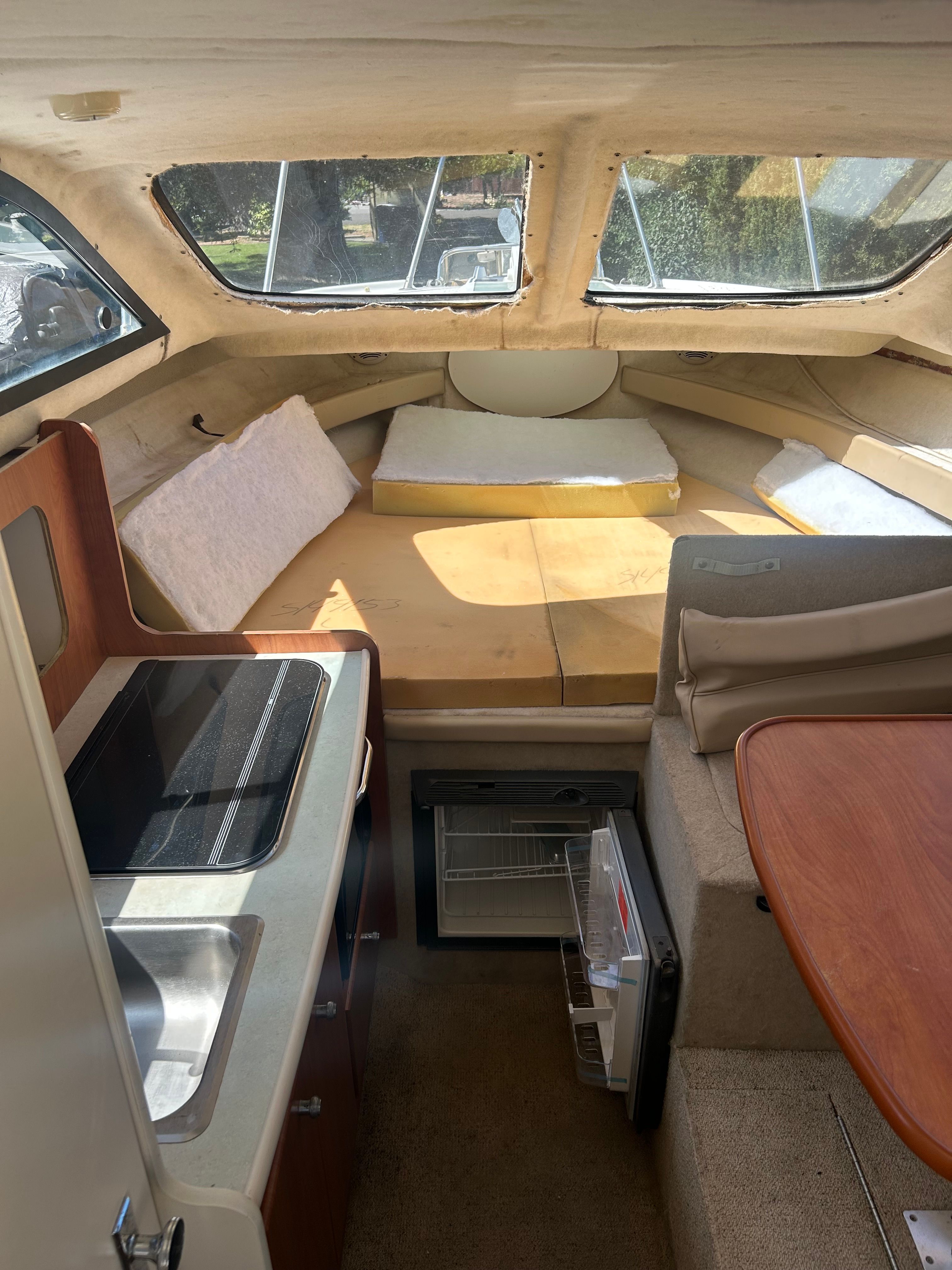 Interior of a 2005 Bayliner Classic 242 with kitchen and sleeping area.