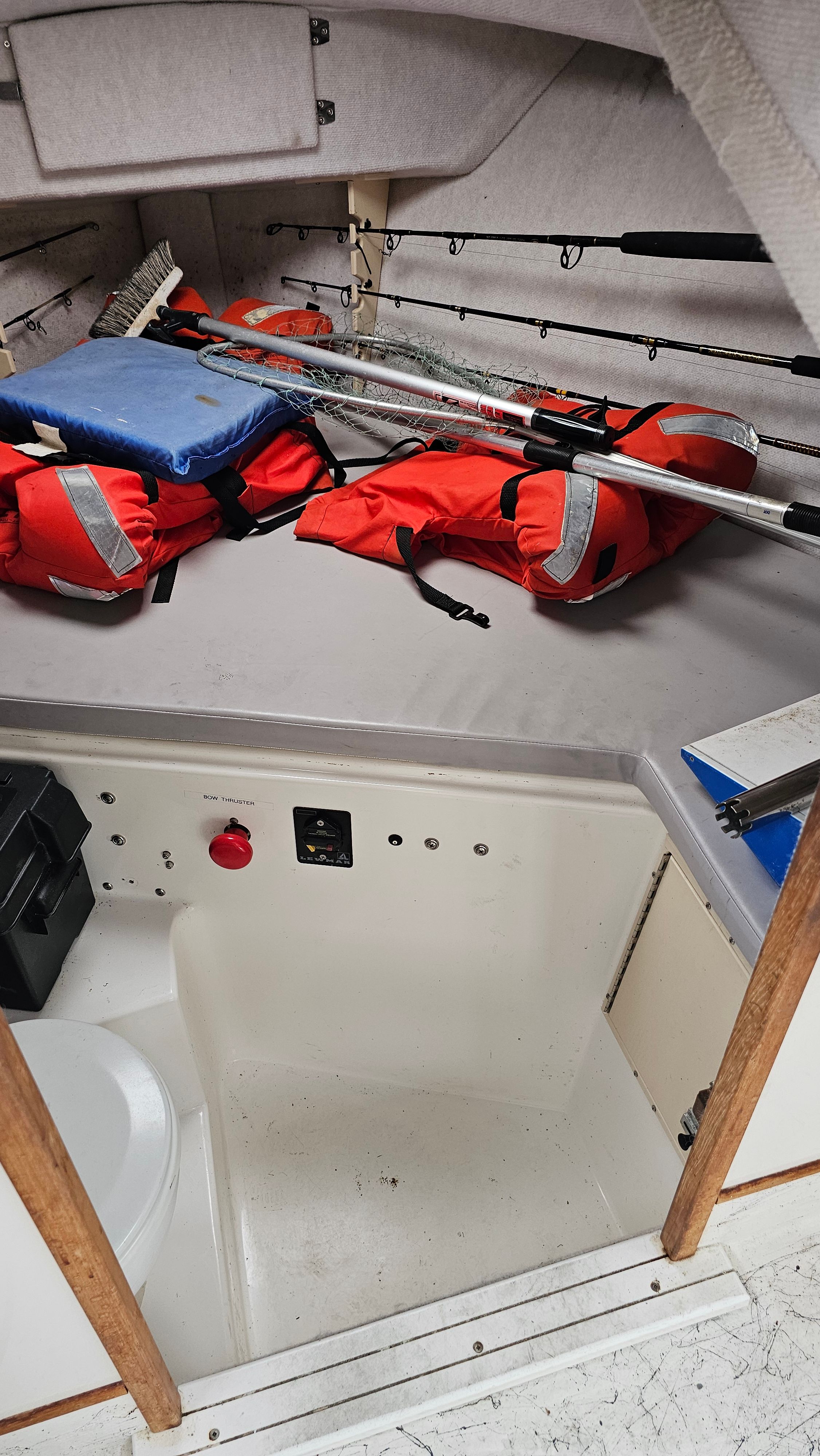 Interior of Osprey 26 EXPEDITION boat with life jackets and fishing rods.