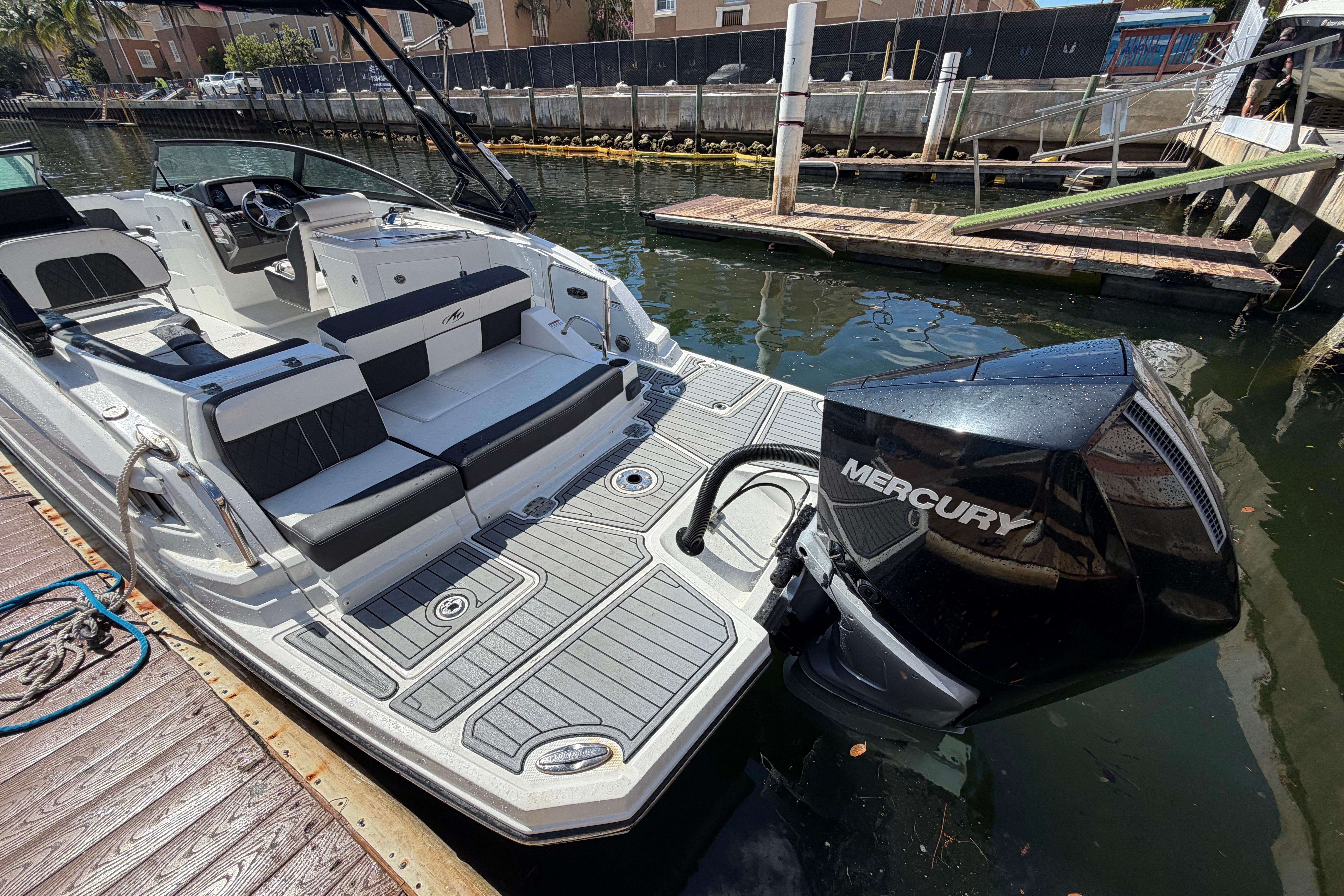 2022 Monterey M-65 boat with Mercury engine docked on a sunny day.