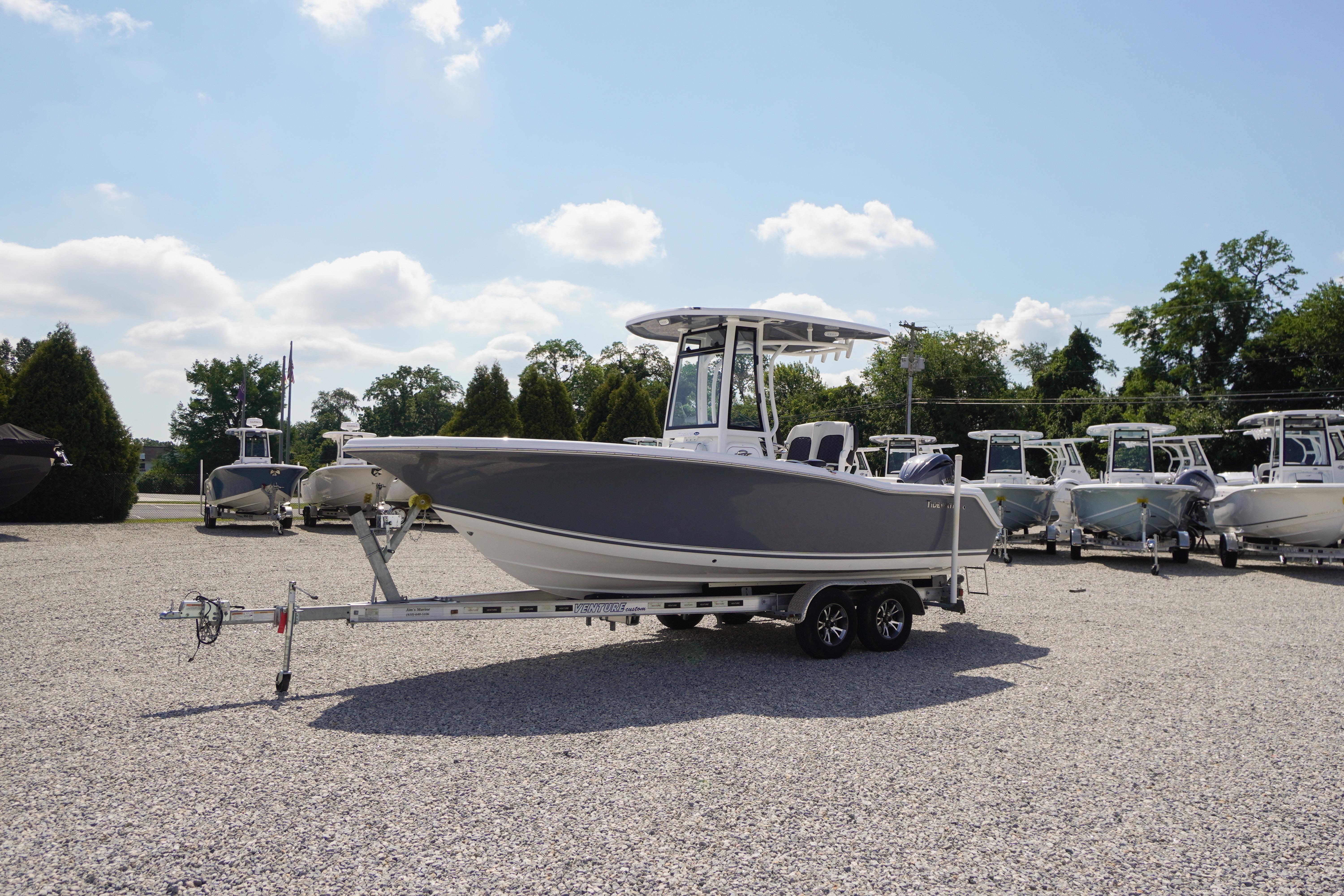 2026 Tidewater 220 CC Adventure boat on trailer in sunny outdoor setting.