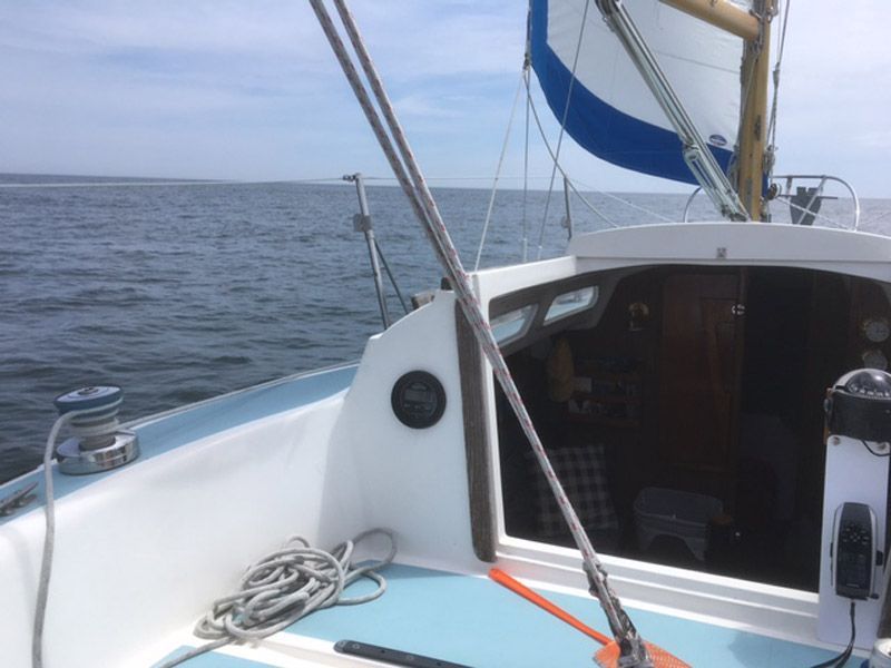 1975 O'Day Sloop sailing on calm sea with sail.