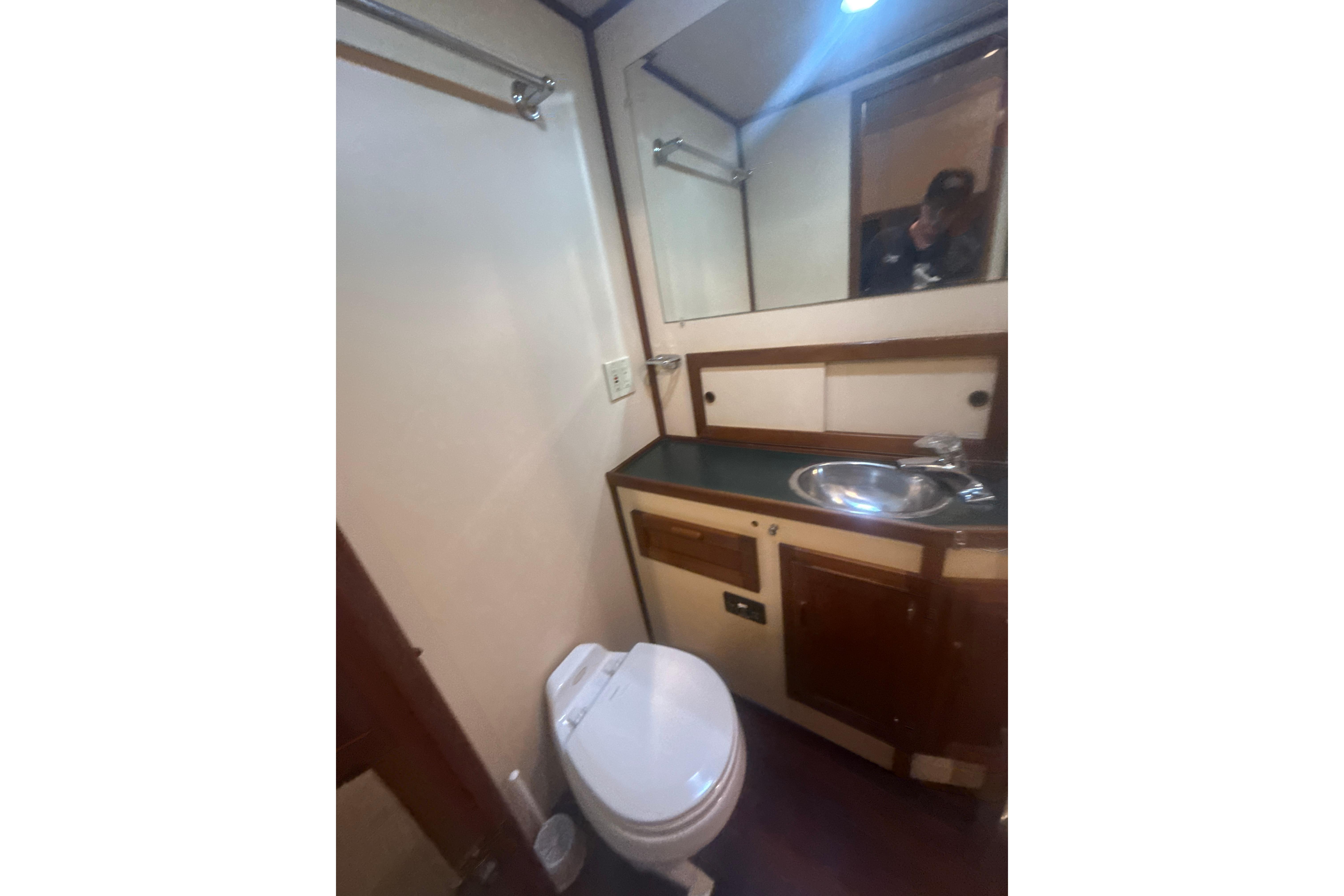 Bathroom interior of a 1997 Nordic Tug 42, featuring sink and toilet.