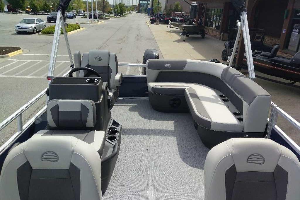 2026 Sun Tracker Bass Buggy 16 XL Select pontoon boat interior with seating and steering console.