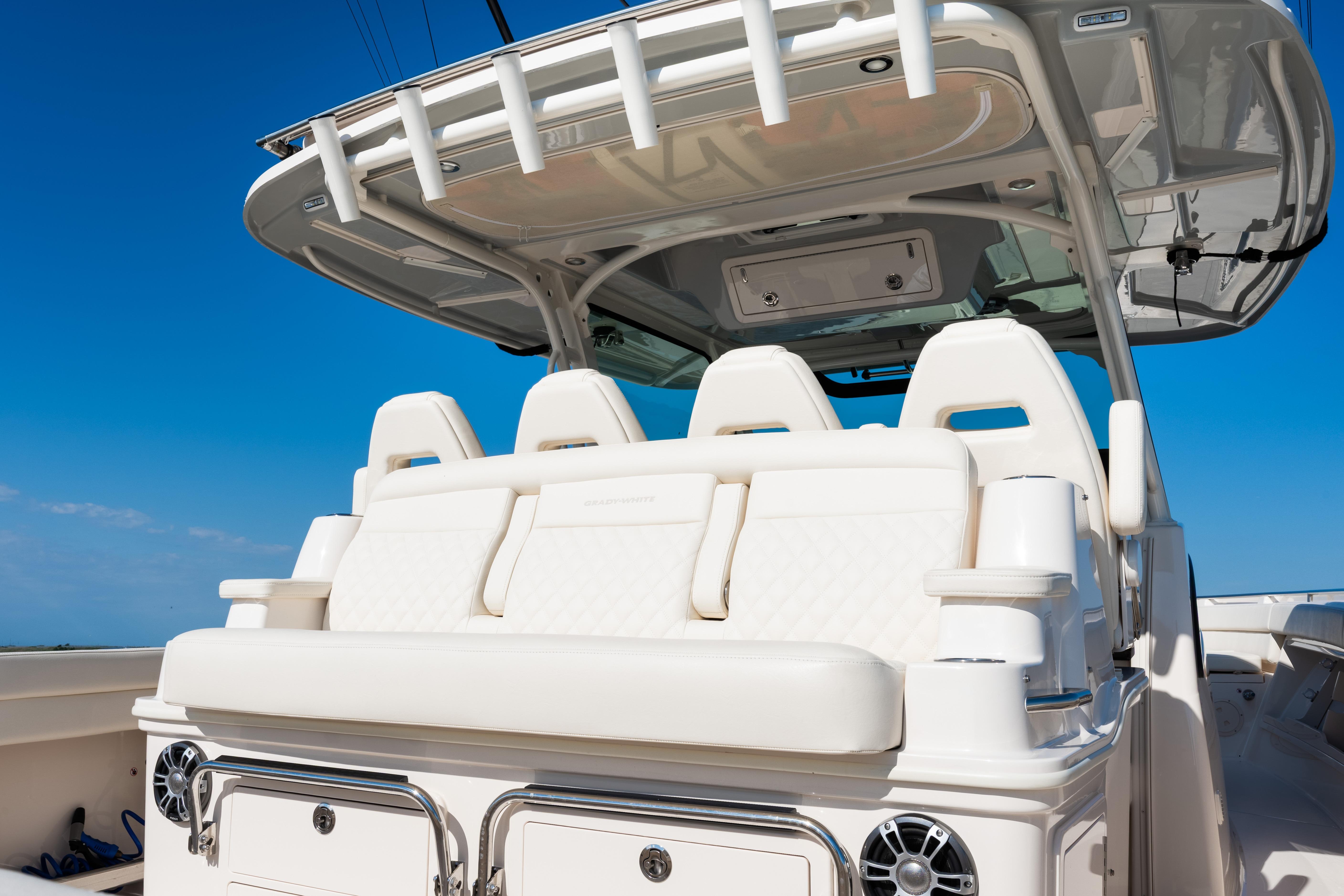 2025 Grady-White Canyon 386 boat interior with luxurious seating under a clear blue sky.