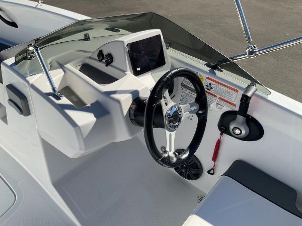 2025 Tahoe T18 boat cockpit with steering wheel and control panel.