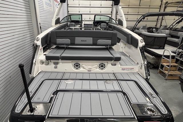 2026 Chaparral SSX 8 boat interior with sleek seating and modern design in a showroom.