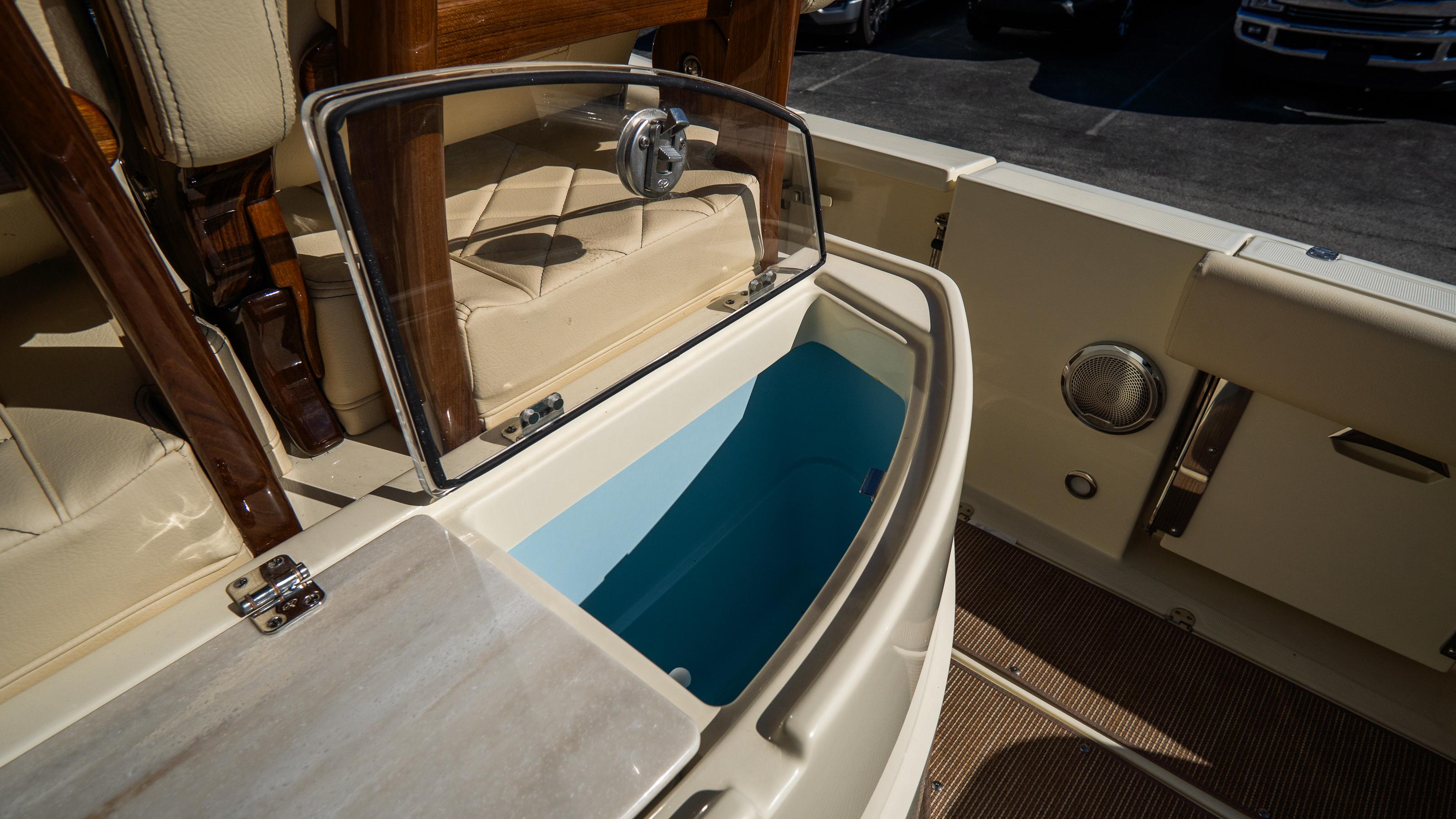 2025 Chris-Craft Catalina 30 boat interior with open storage compartment.