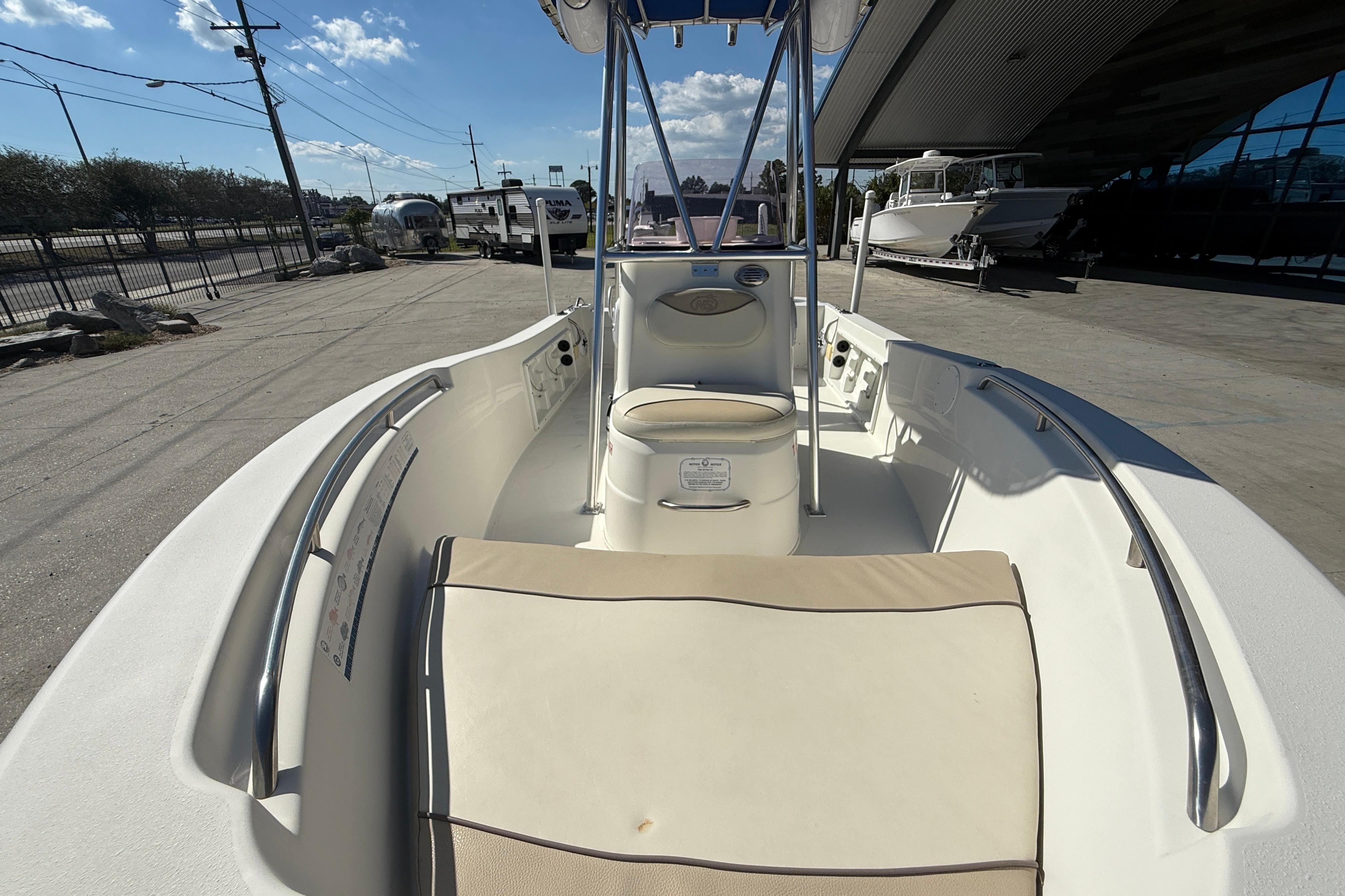 2019 NauticStar 19 XS boat interior with seating and console, docked outdoors.