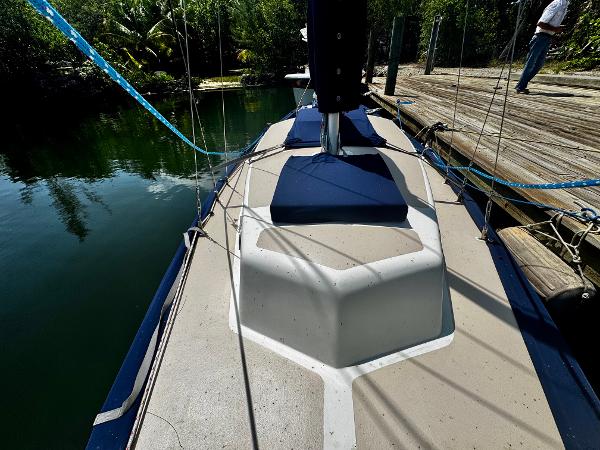 1968 Sailboat 24 docked, showing deck and rigging in a serene marina setting.