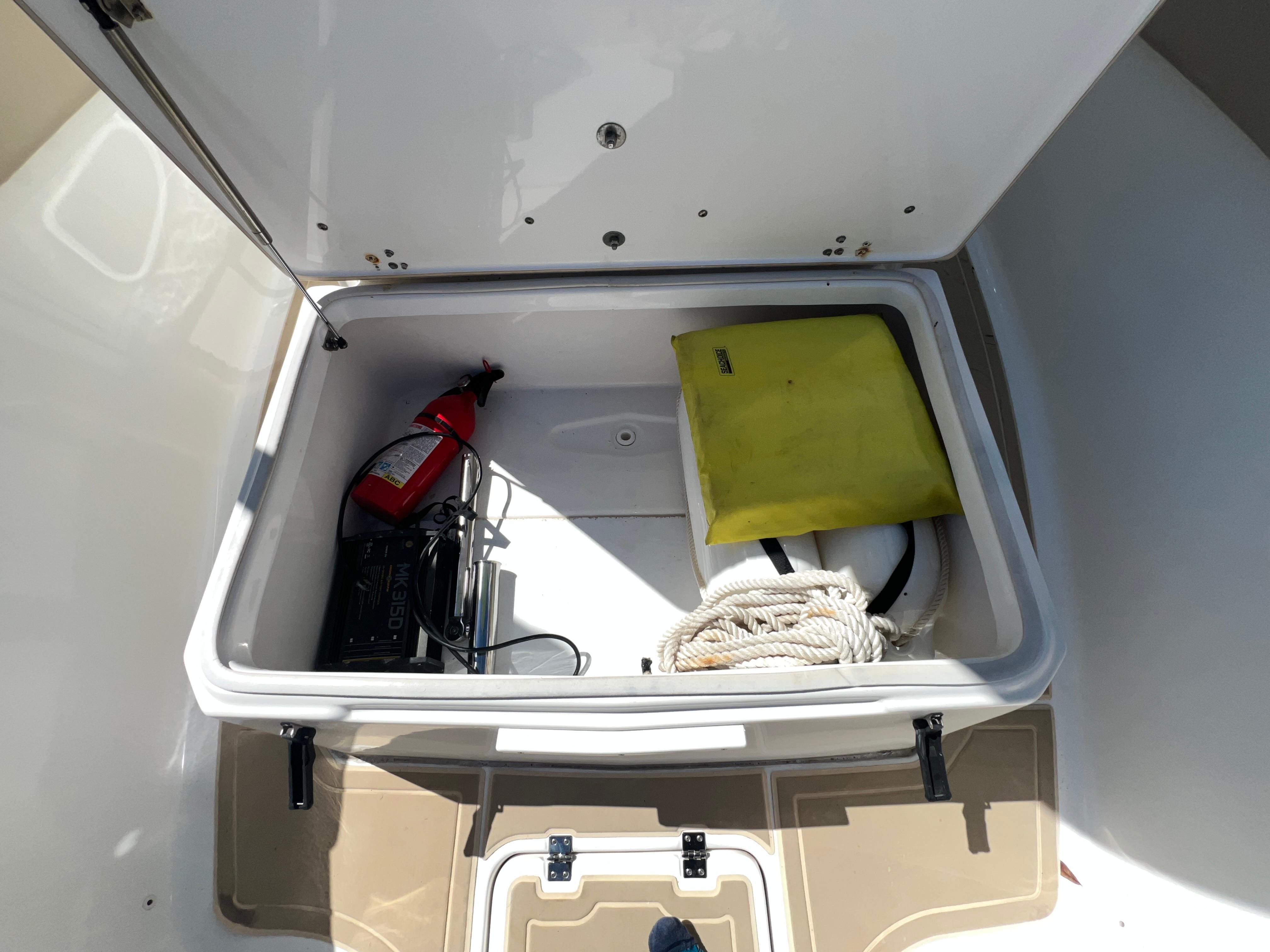 Storage compartment of 2016 Sea Fox 266 Commander with safety equipment and rope.