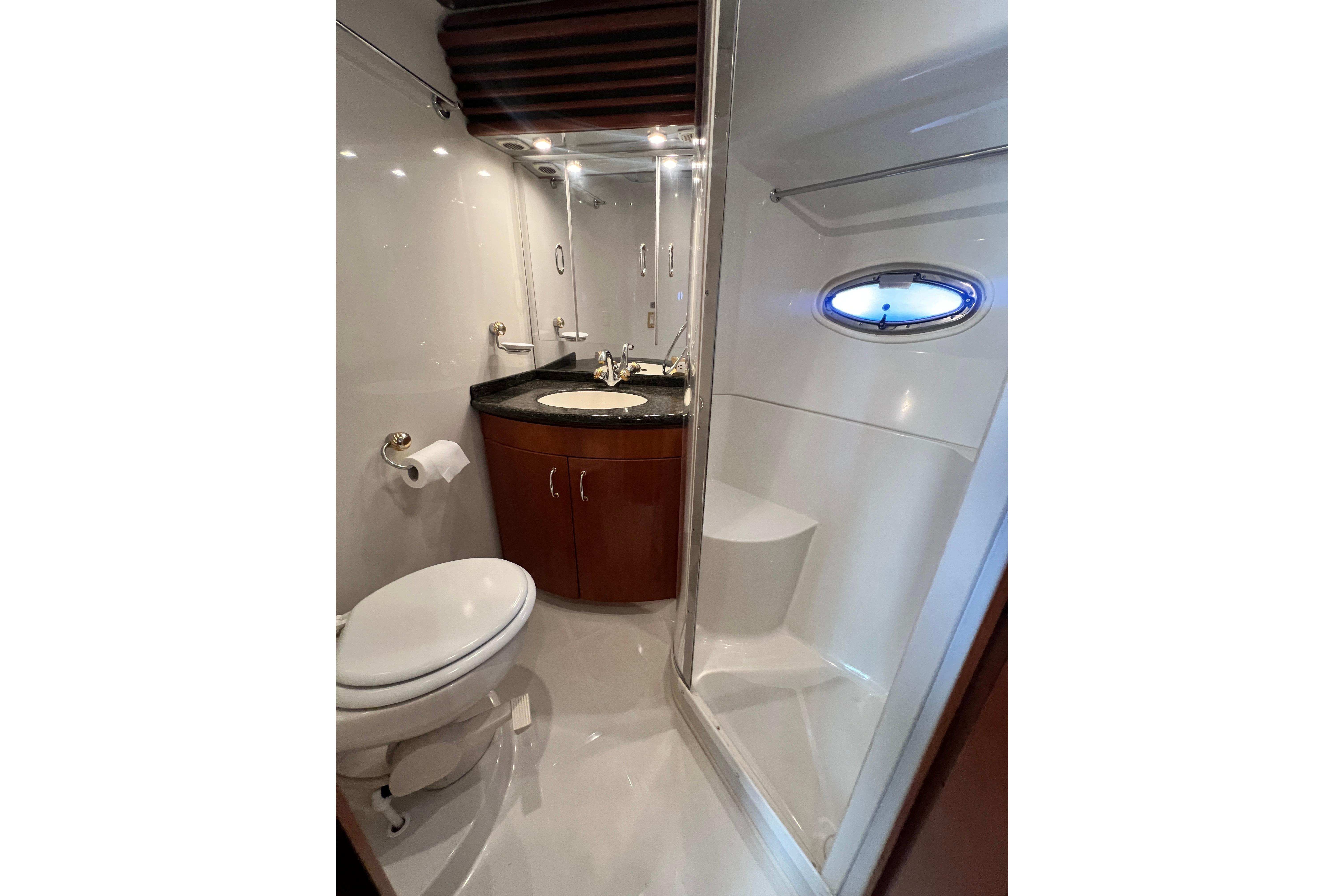Luxurious bathroom in 2003 Carver 450 Voyager Pilothouse yacht with modern fixtures.