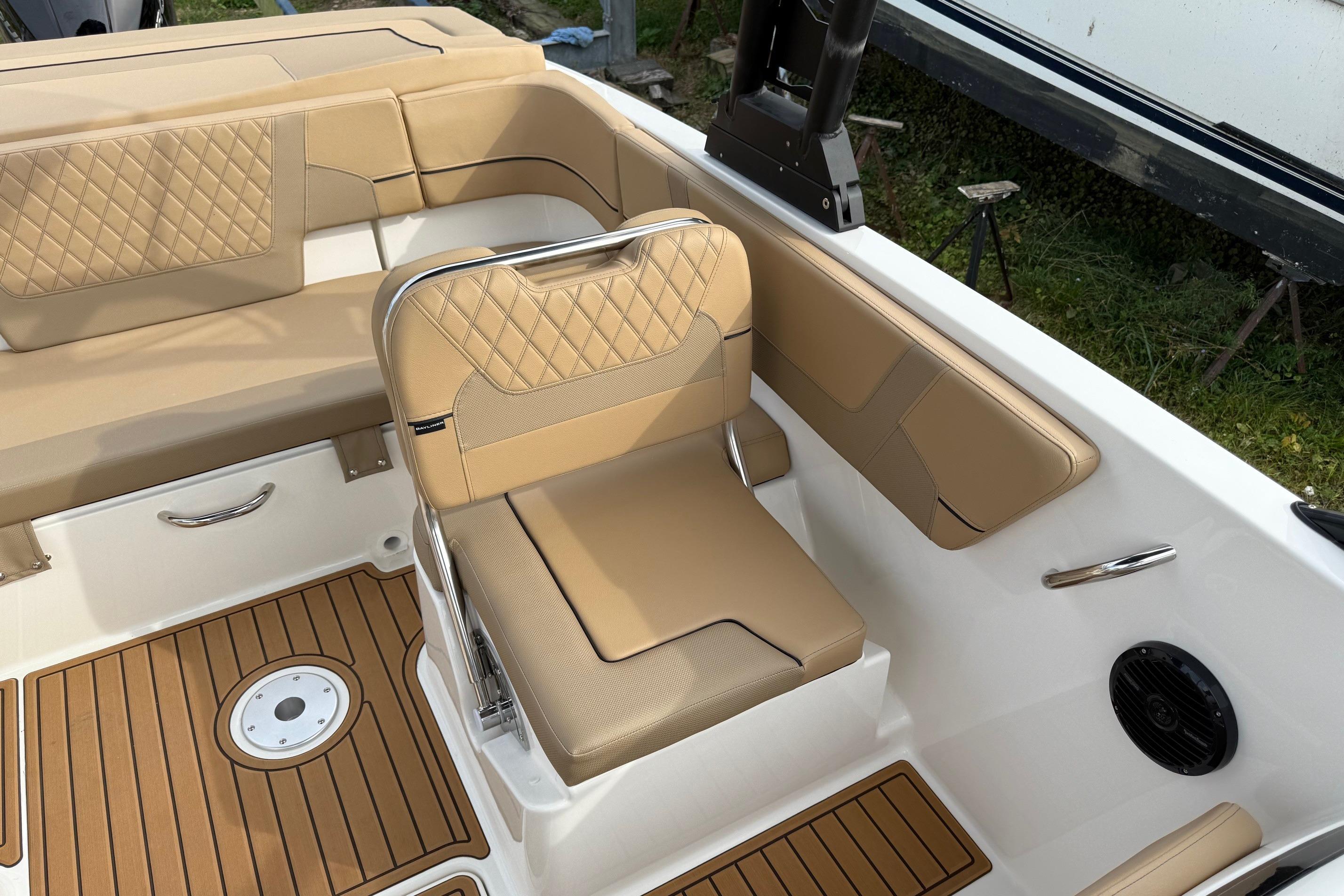 Luxurious interior of 2026 Bayliner VR6 Bowrider OB with tan seating and teak flooring.
