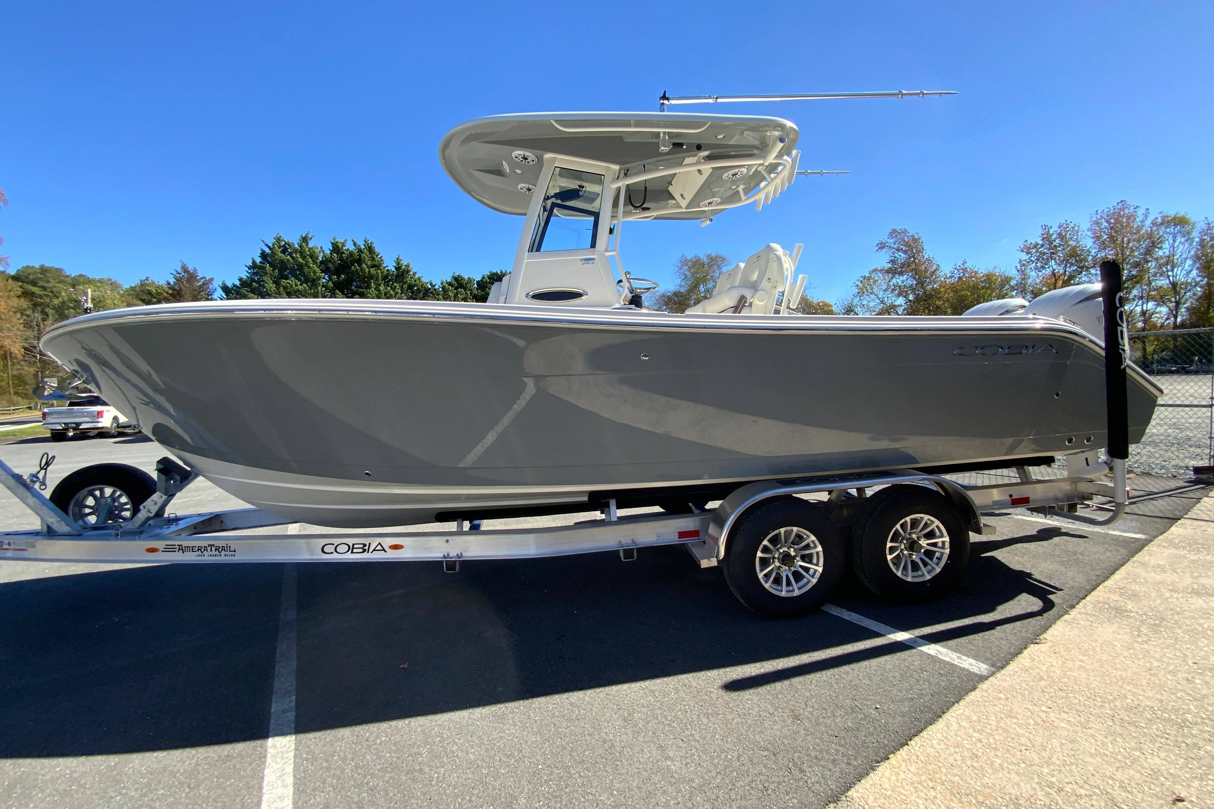 2026 Cobia 265 Center Console boat on trailer in parking lot.