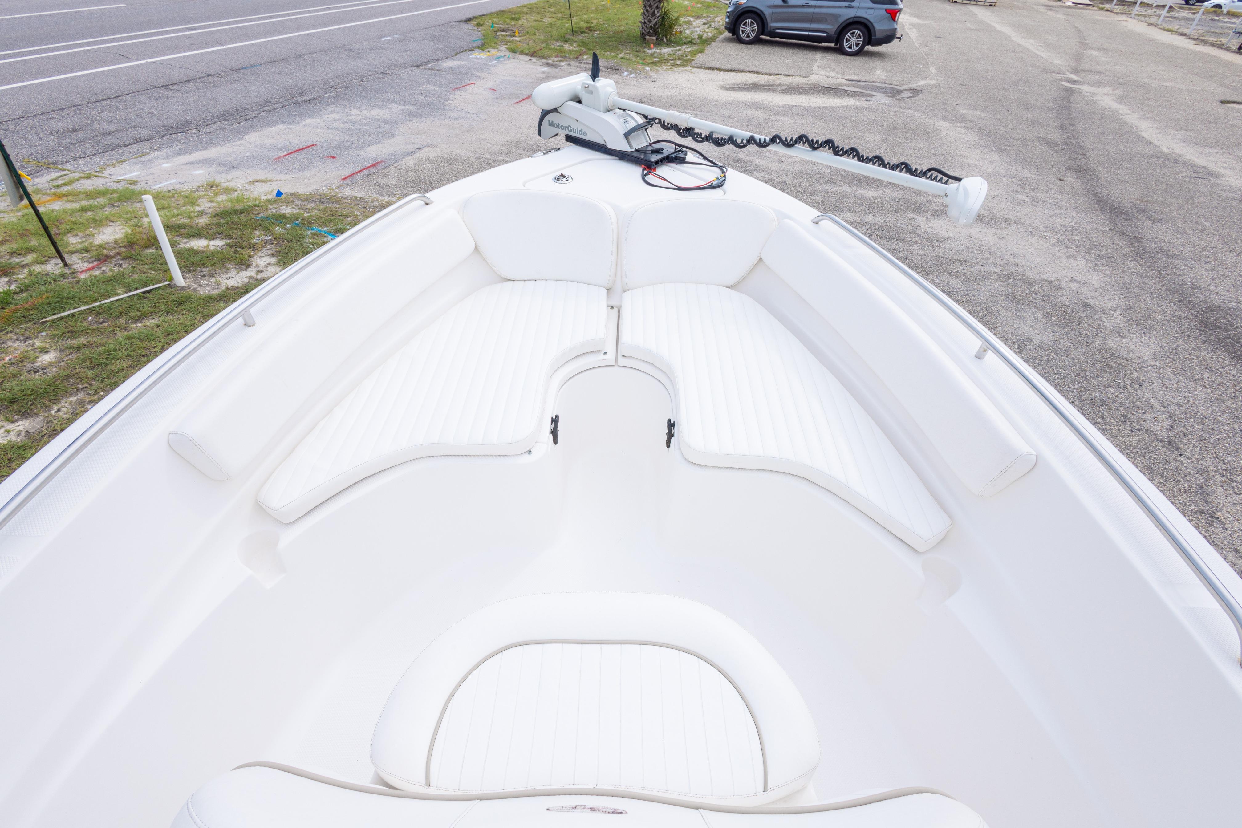 2014 Sea Fox 209 Commander boat with white cushioned seating and trolling motor.