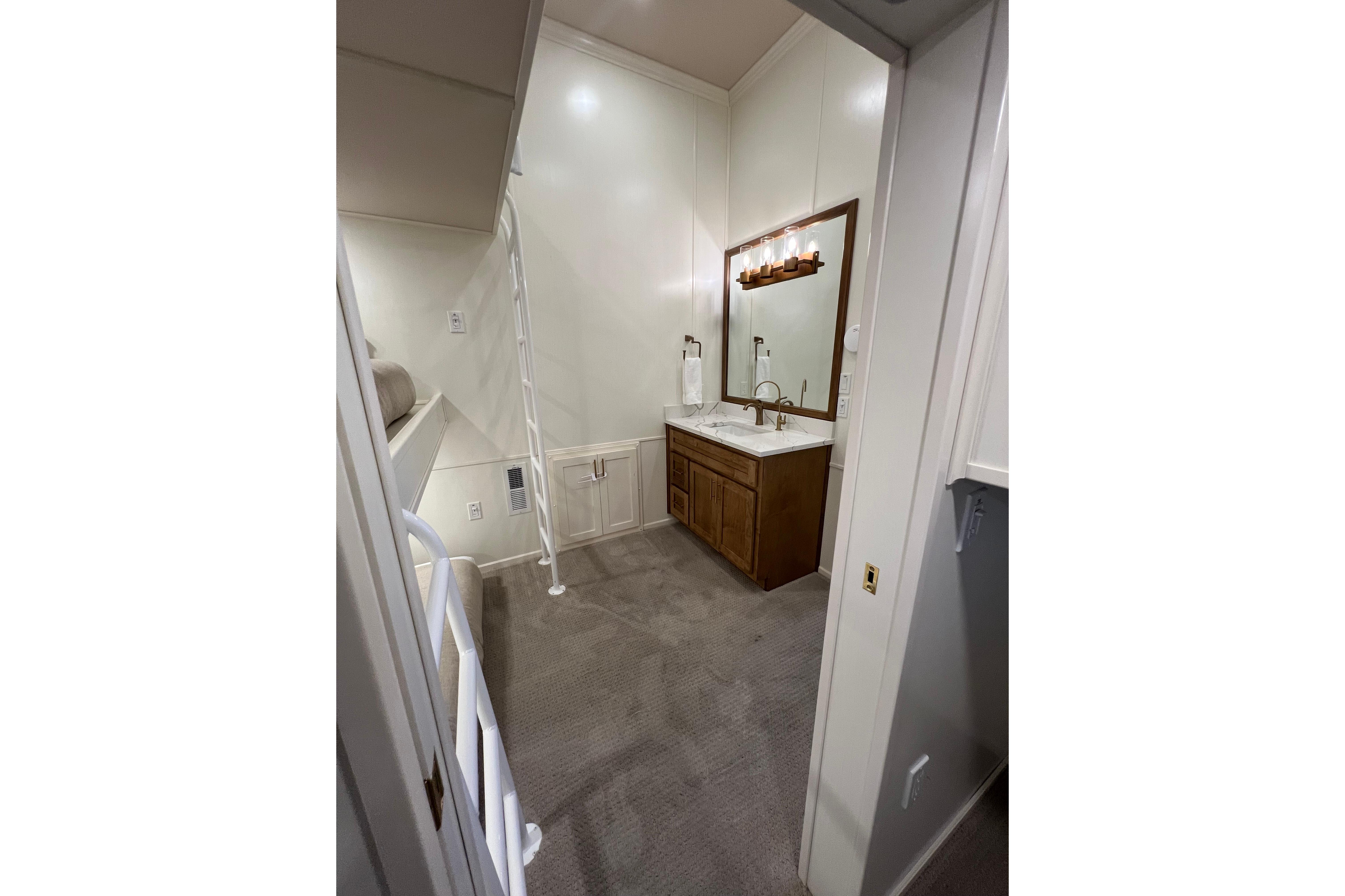 Interior of 2025 Sumerset Excellence Multiple Shares with bunk beds and vanity area.