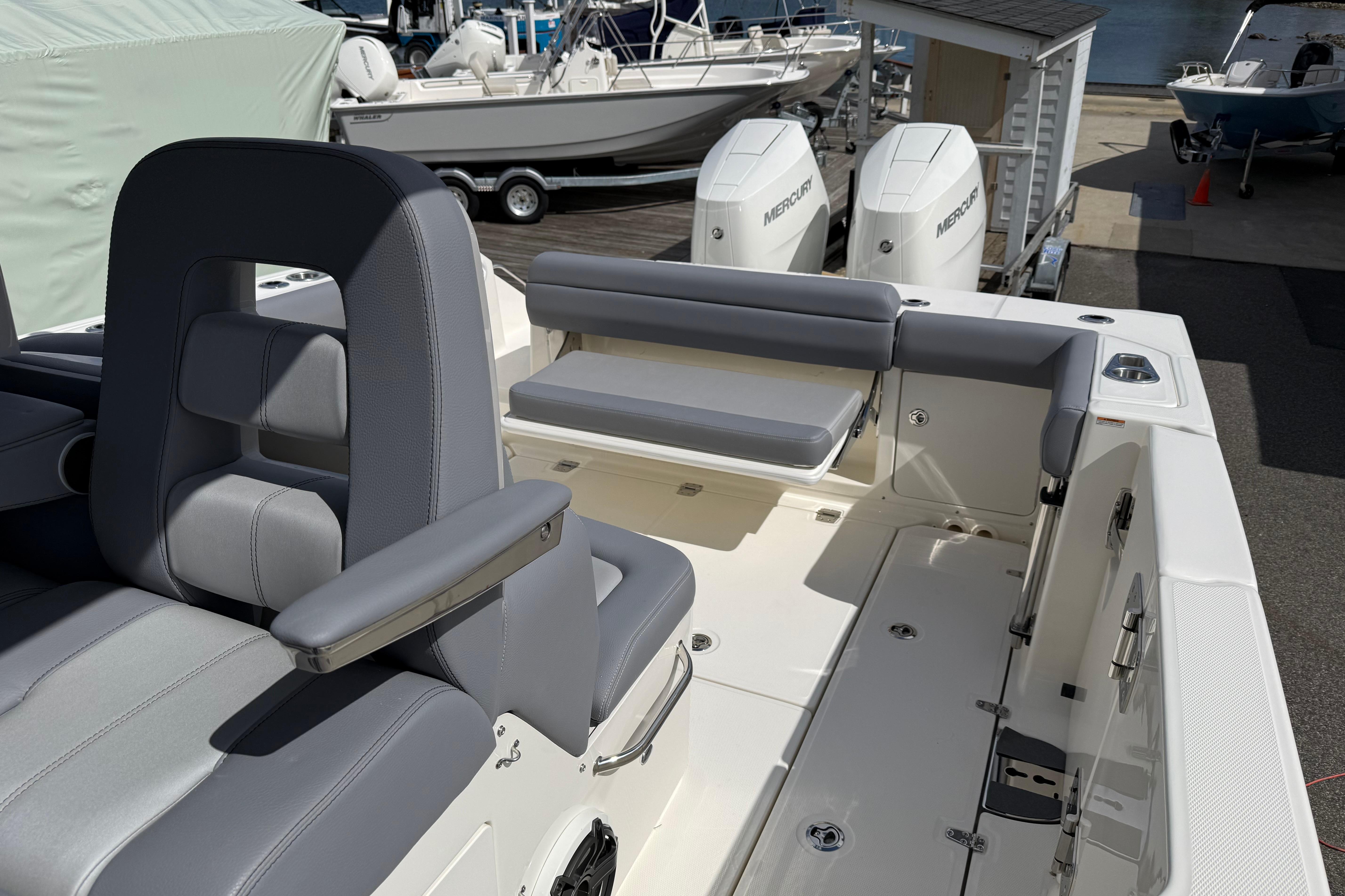 2026 Boston Whaler 330 Outrage boat interior with seating and dual Mercury engines.