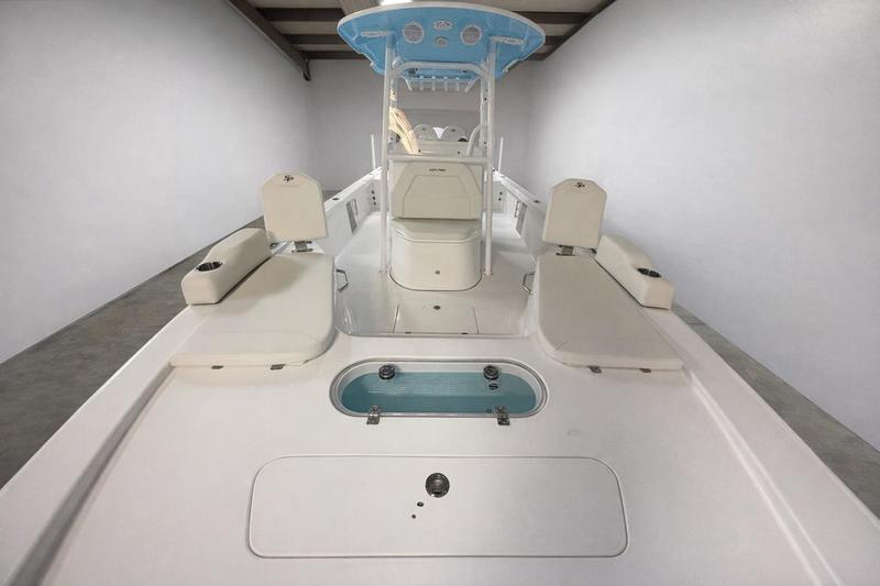 2026 Sea Pro 250 Bay boat interior with seating and storage compartments.