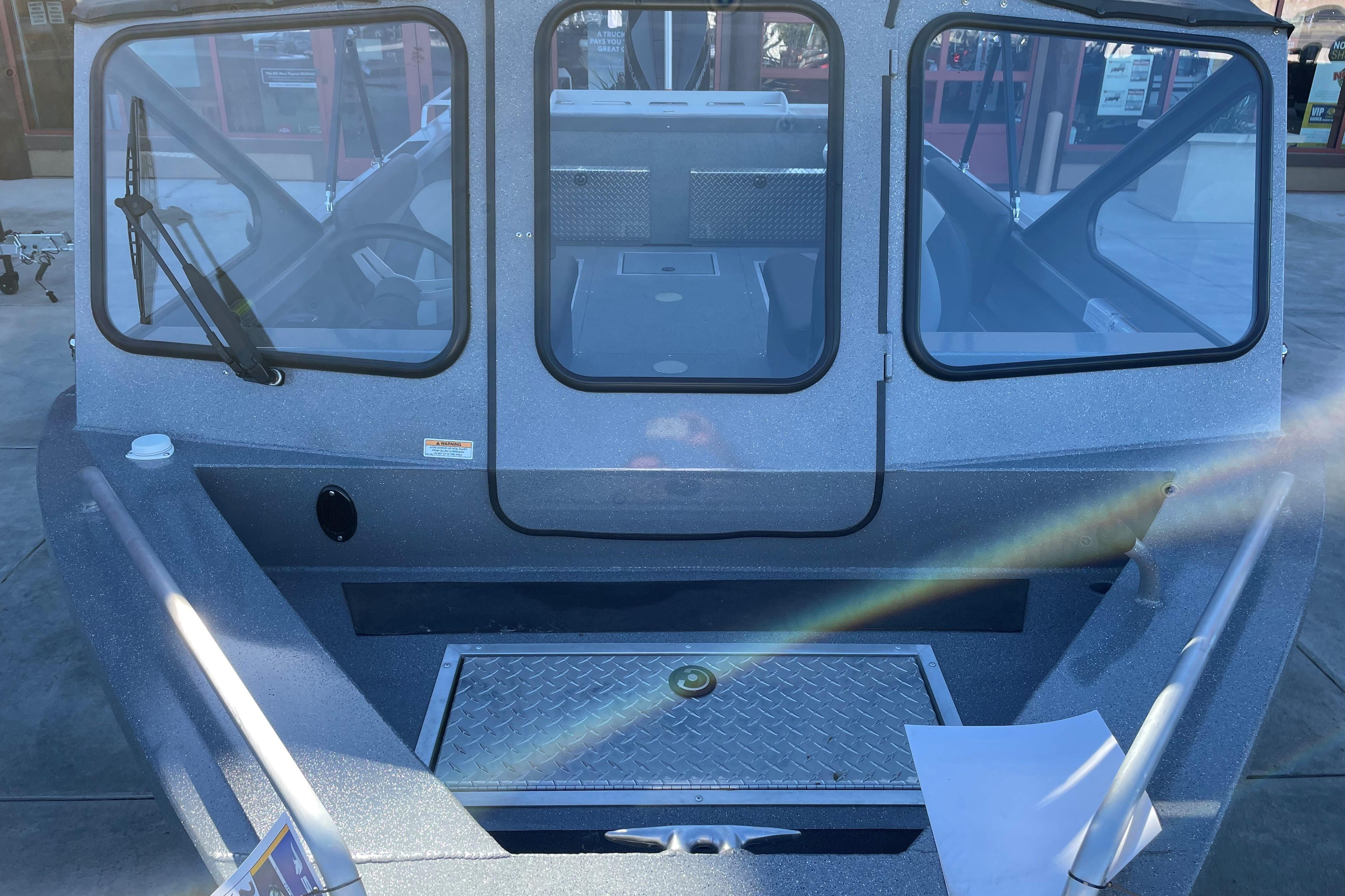 2025 Spartan 200 Astoria boat with windshield and deck view.