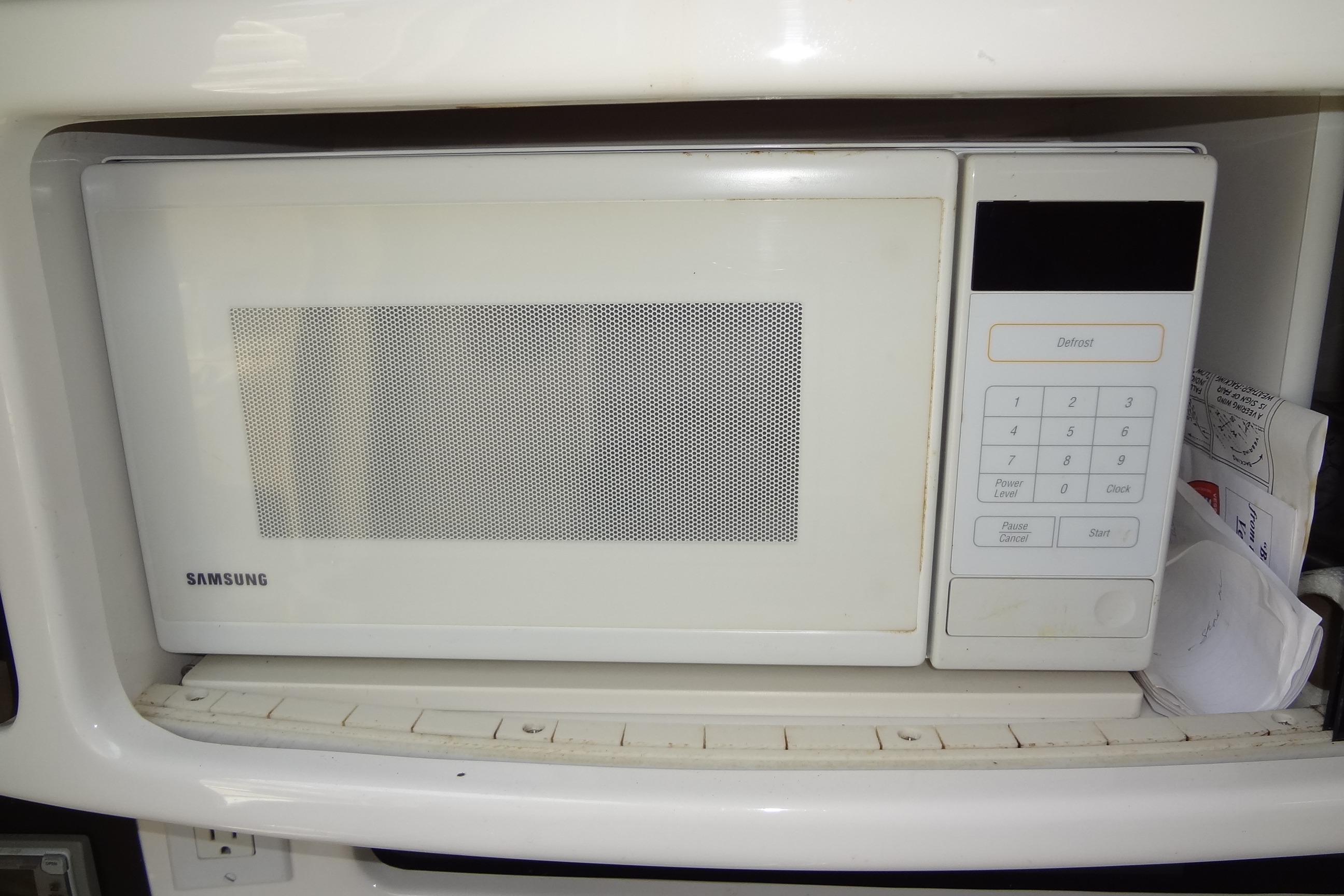 Samsung microwave inside a 2000 Chaparral Signature 260 boat kitchen area.