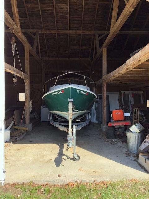 A 1990 Custom North End Composites Point boat stored in a wooden garage.