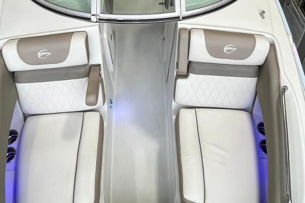 2023 Crownline Eclipse E235 XS boat interior with white and beige seating, illuminated cup holders.