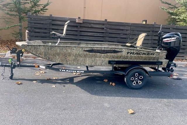 2026 Tracker Grizzly 1650 T Prairie Wings Edition boat on trailer, outdoors.