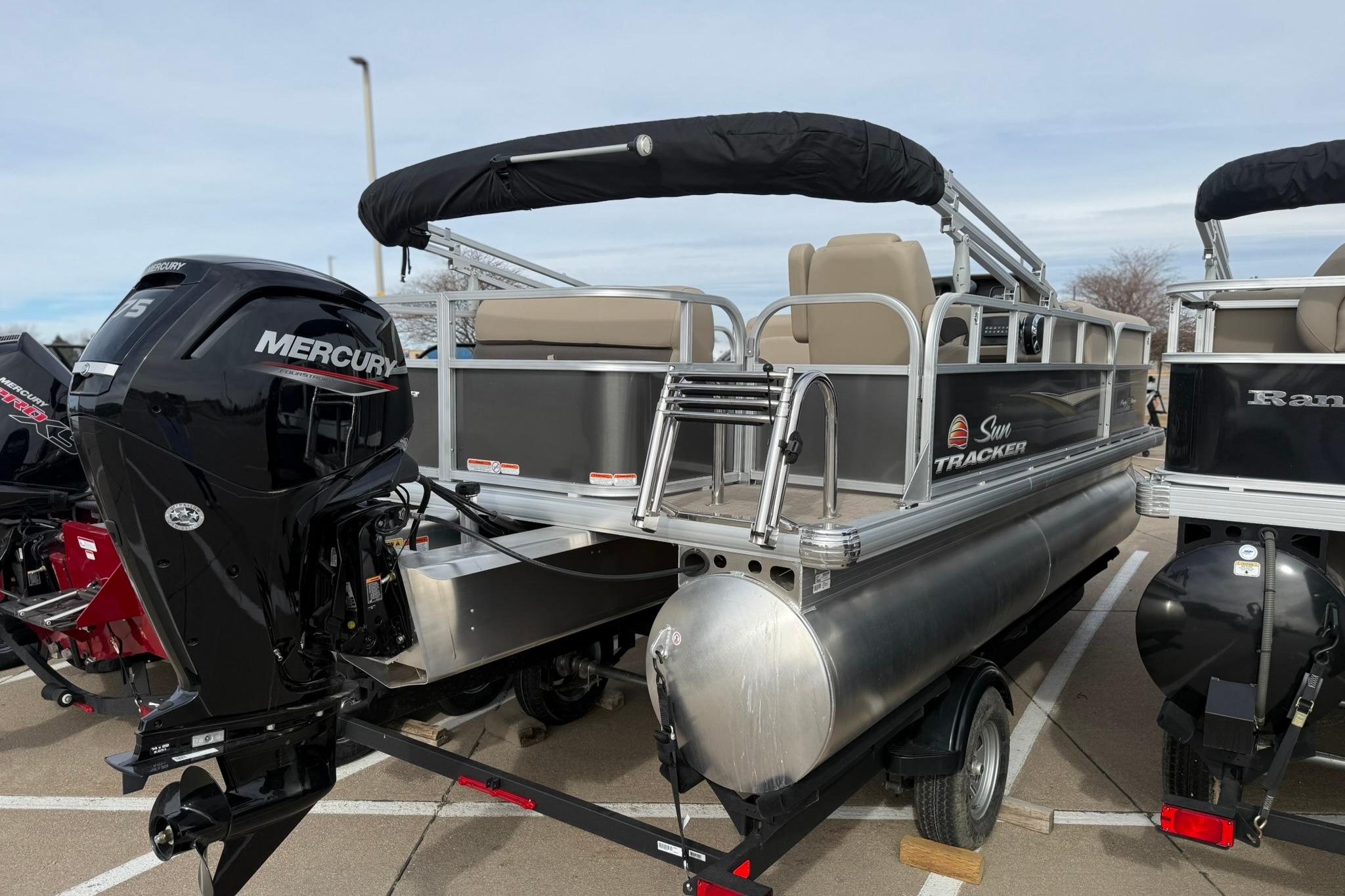 2025 Sun Tracker Party Barge 18 DLX pontoon boat with Mercury outboard motor.