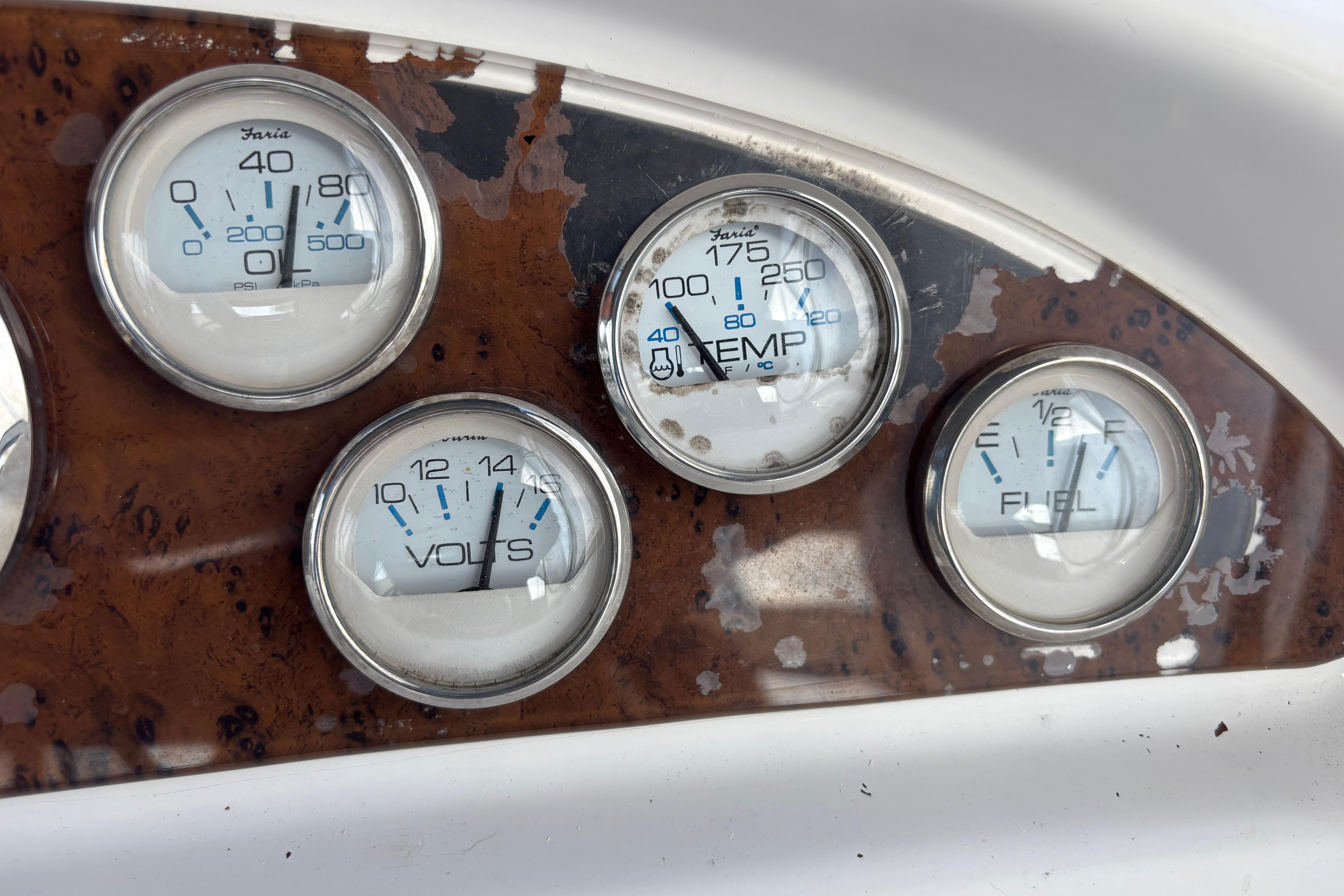 Dashboard gauges of a 2001 Silverton 410 Sport Bridge boat, showing pressure, temperature, volts, and fuel.