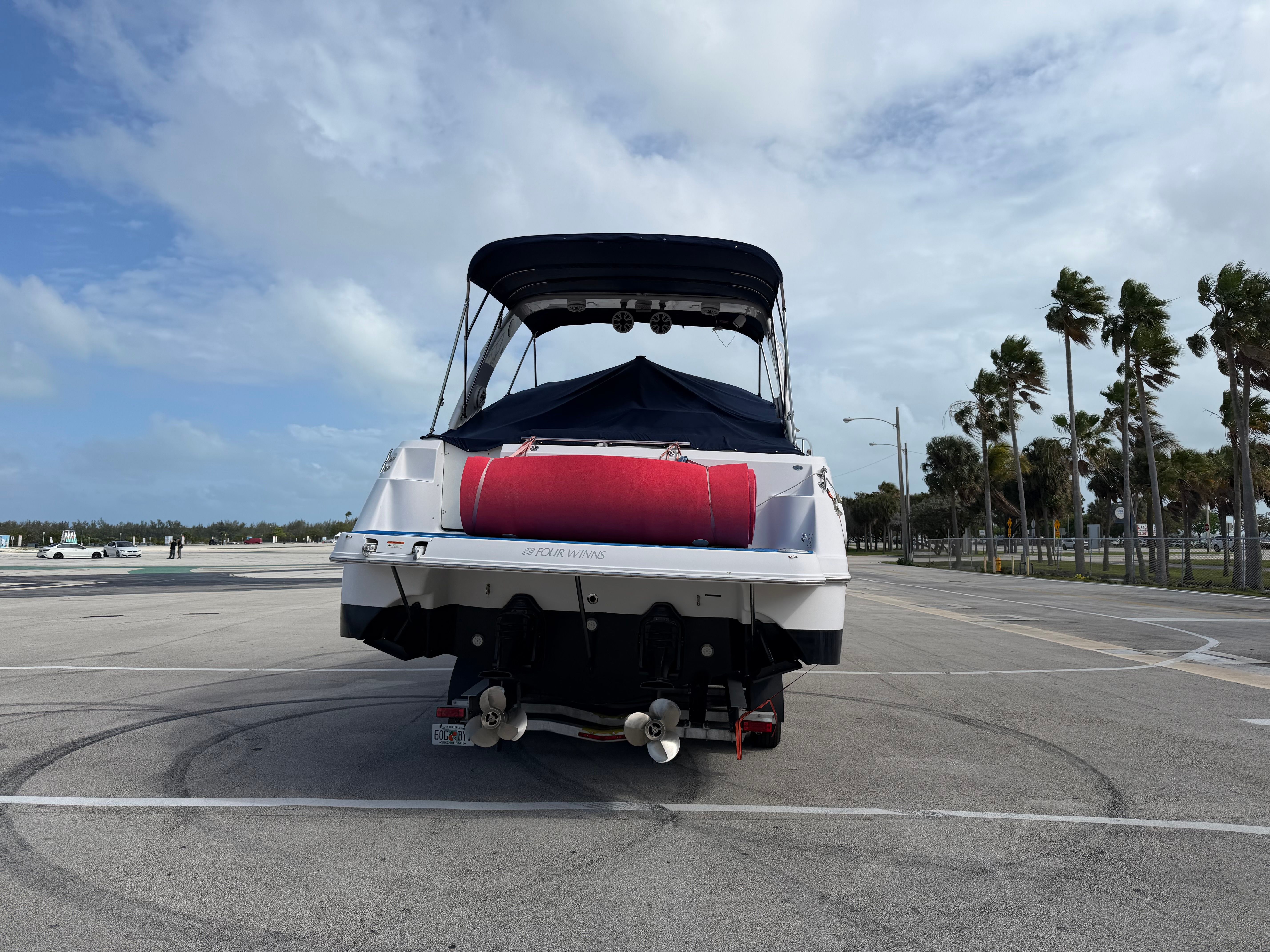 2006 Four Winns 328 Vista boat on a parking lot.