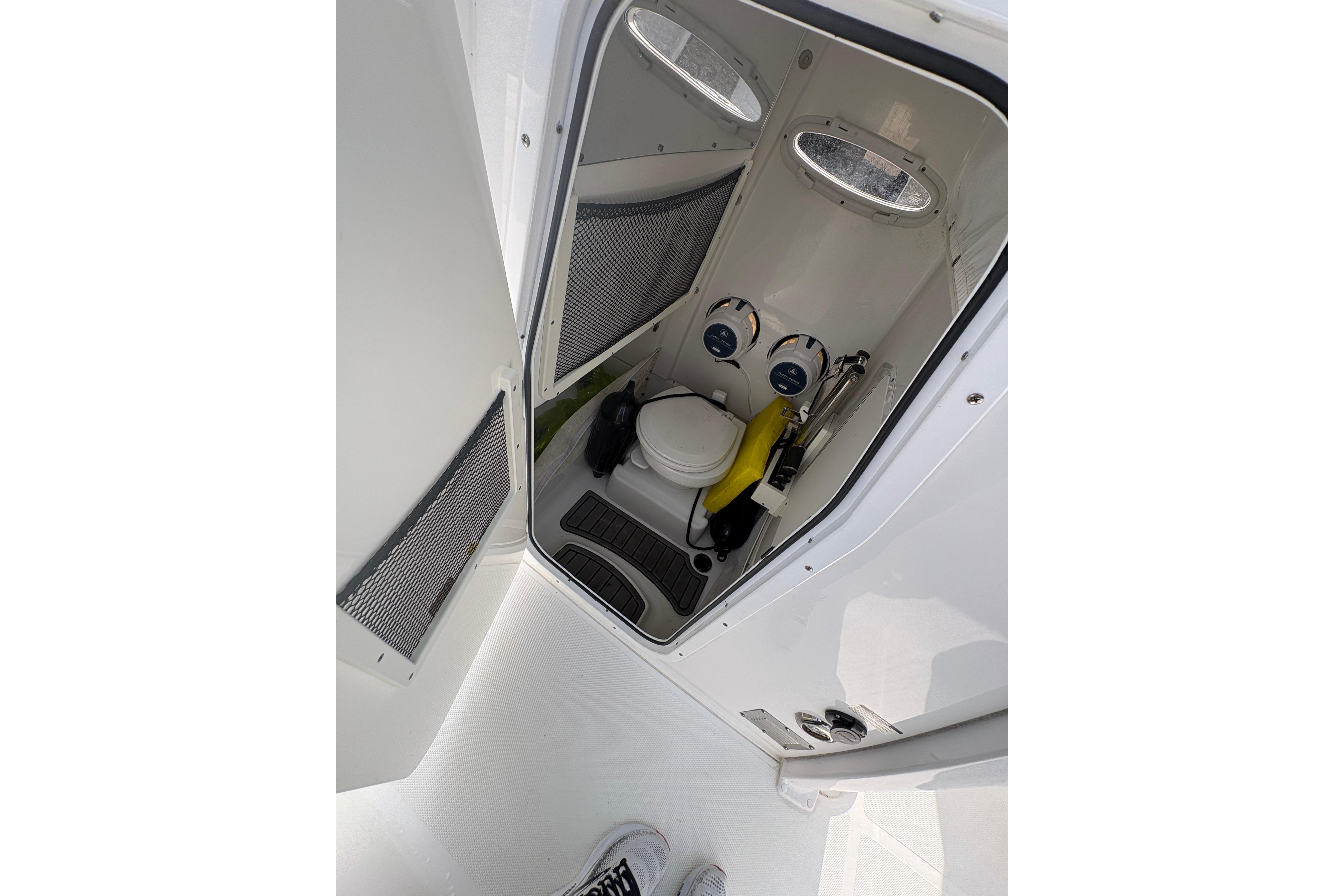 Interior view of 2021 Sea Hunt Ultra 265 SE boat's compact restroom.