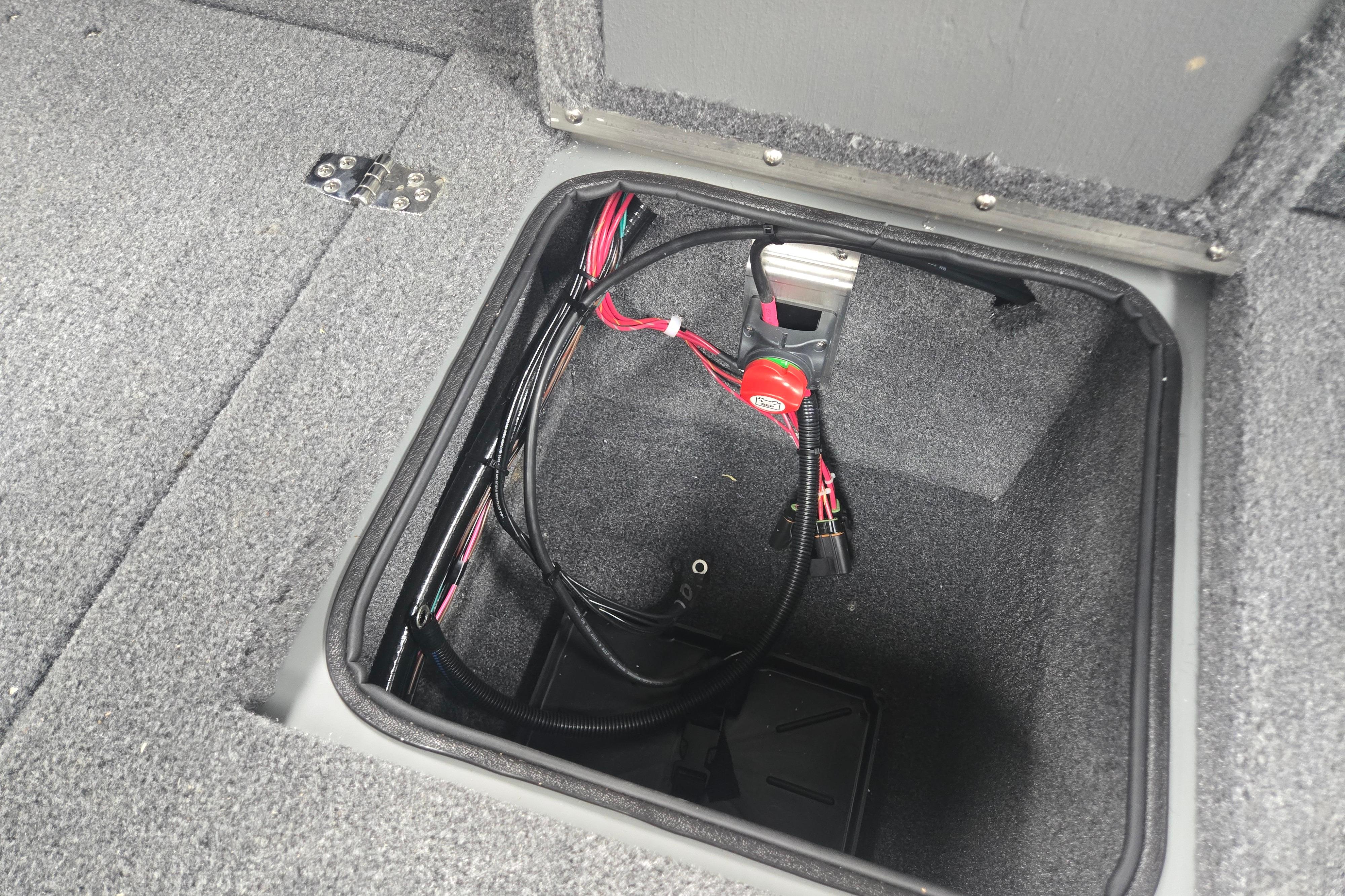 Open storage compartment in 2026 Princecraft Sport 175 MAX boat, showing wiring and carpeted interior.