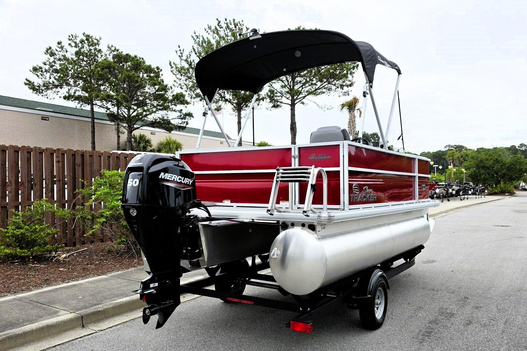 2026 Sun Tracker Party Barge 16 DLX pontoon boat with Mercury engine on trailer.