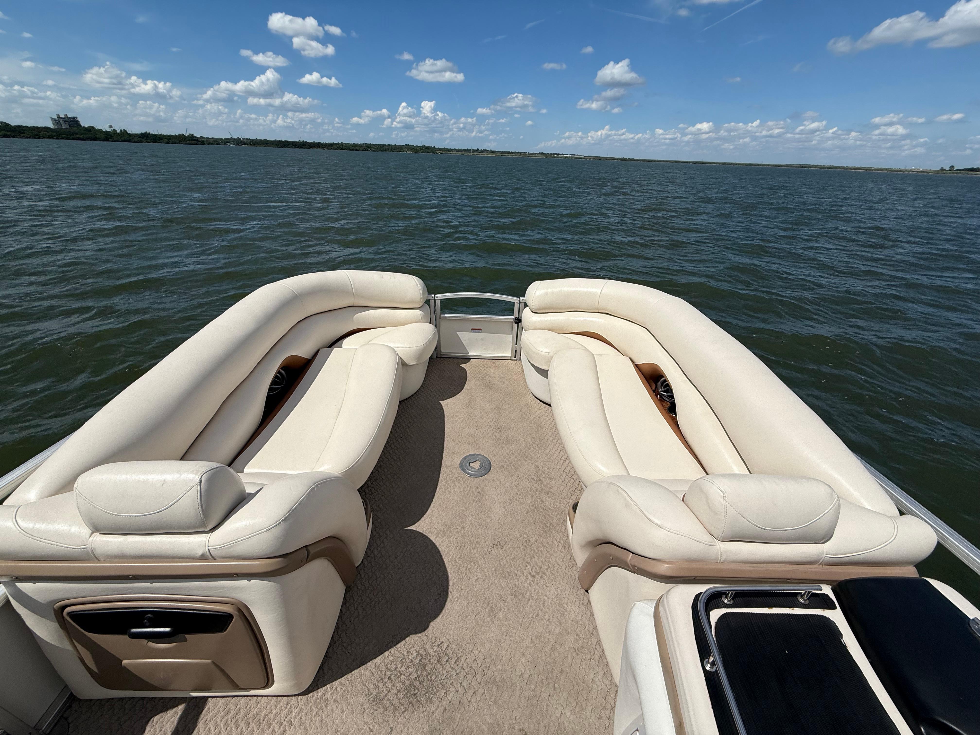 2011 Sun Tracker Regency Party Barge 22 on a lake, featuring spacious seating and clear skies.
