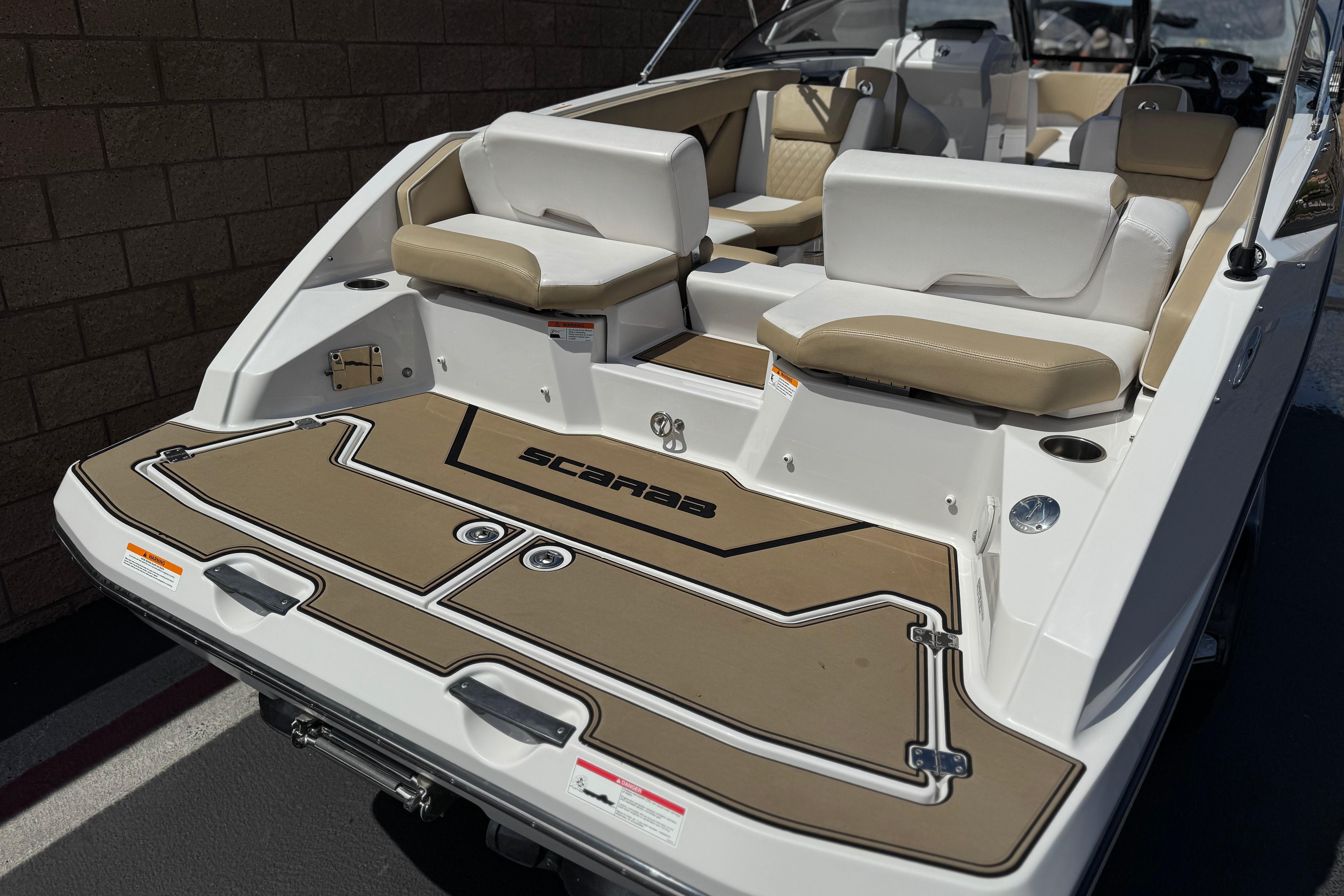 2017 Scarab 255 H.O. Platinum boat with tan and white seating, rear view.