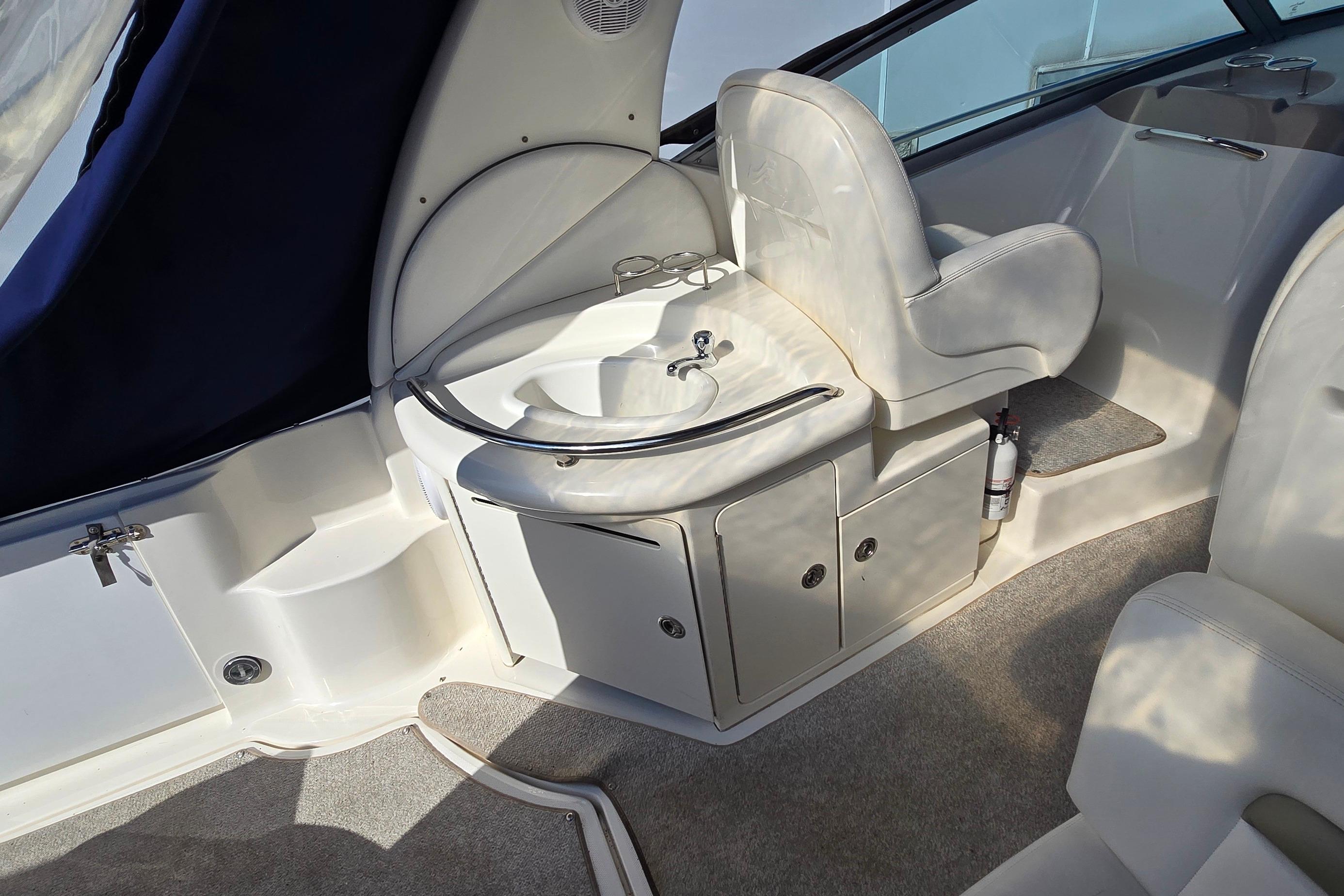 Interior of 2007 Sea Ray 340 Sundancer boat with sink and seating area.